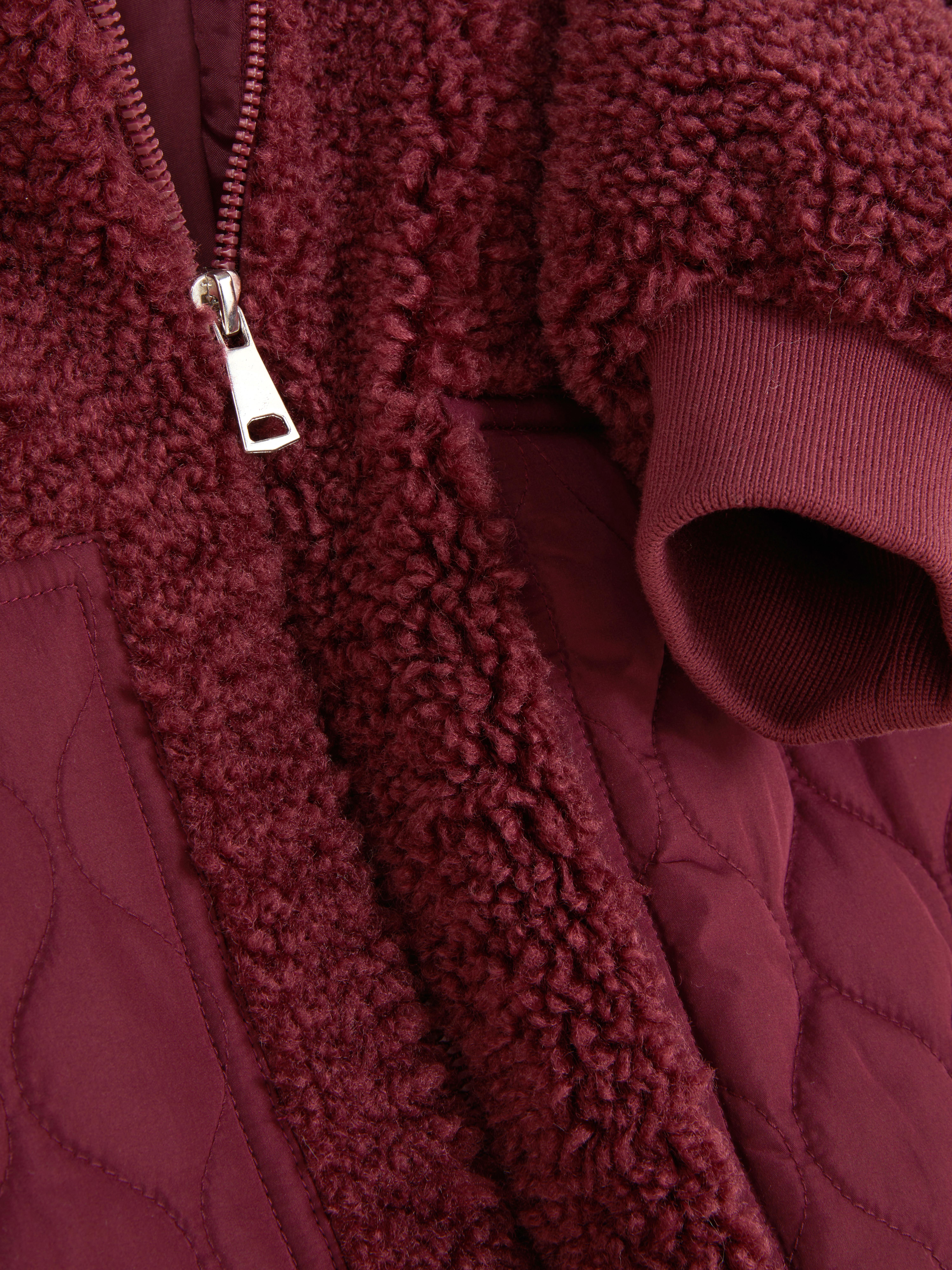 Casaco malha polar bolso contrastante
