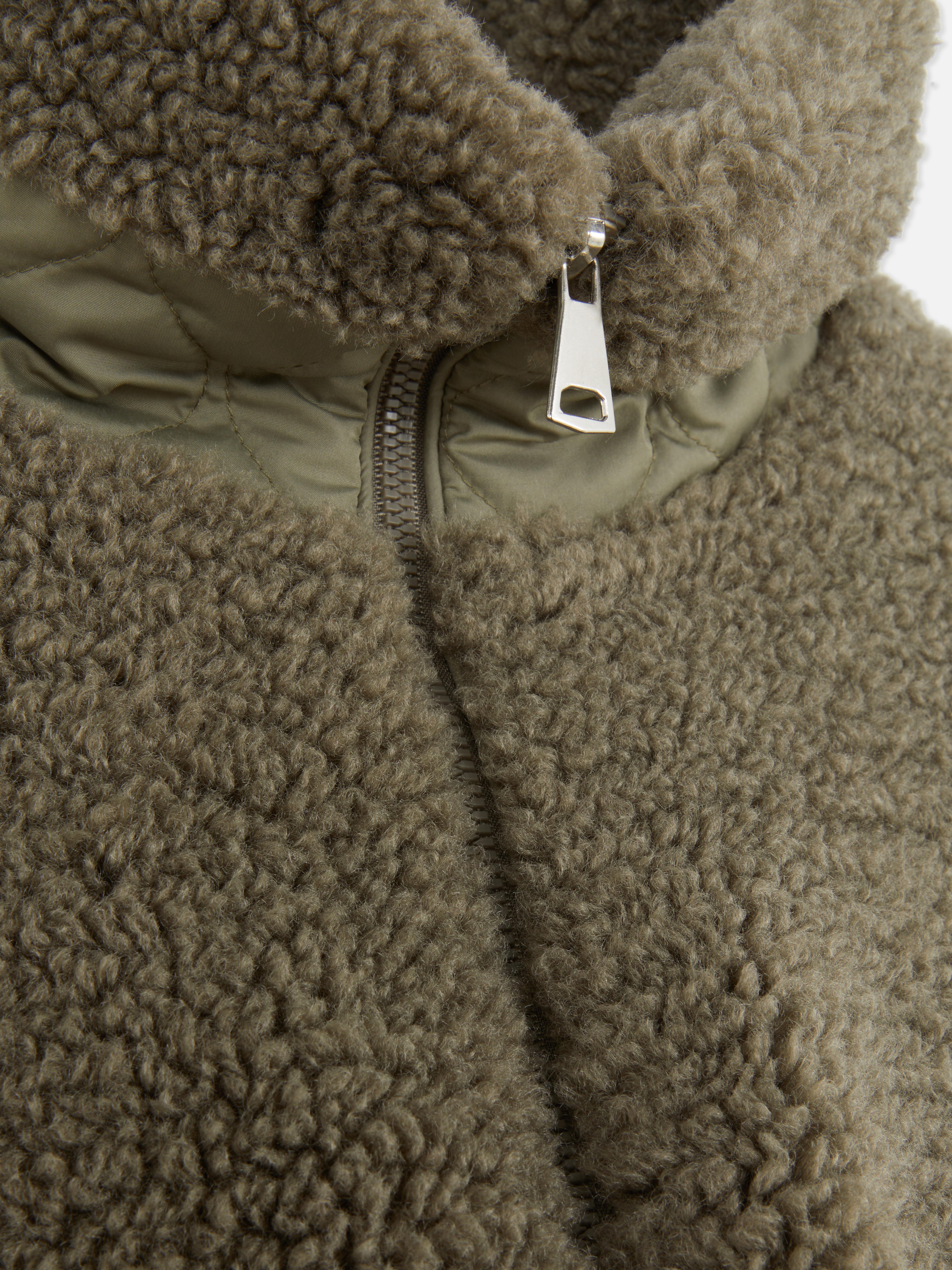 Casaco malha polar bolso contrastante