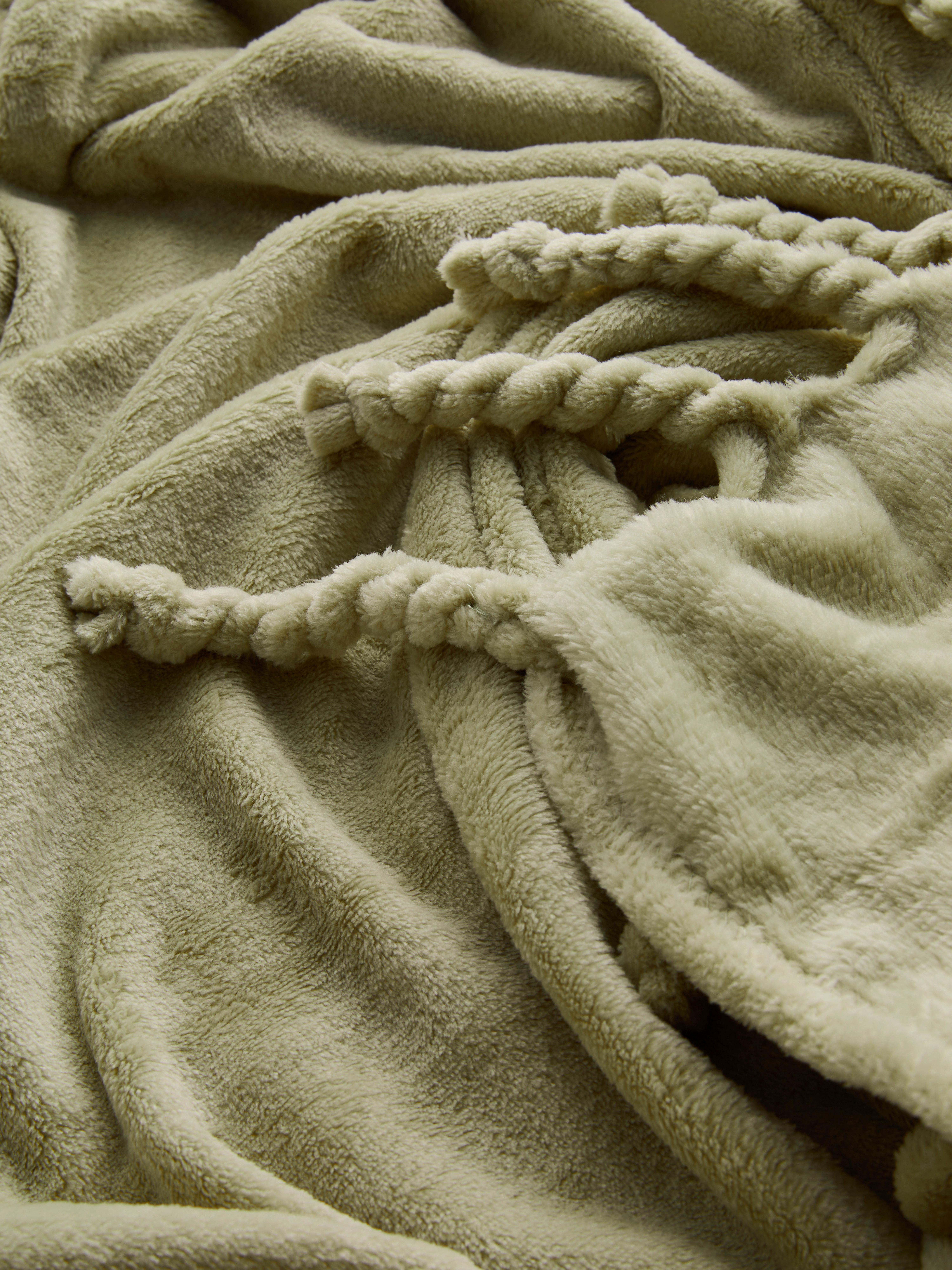 Zachte deken met kwastjes