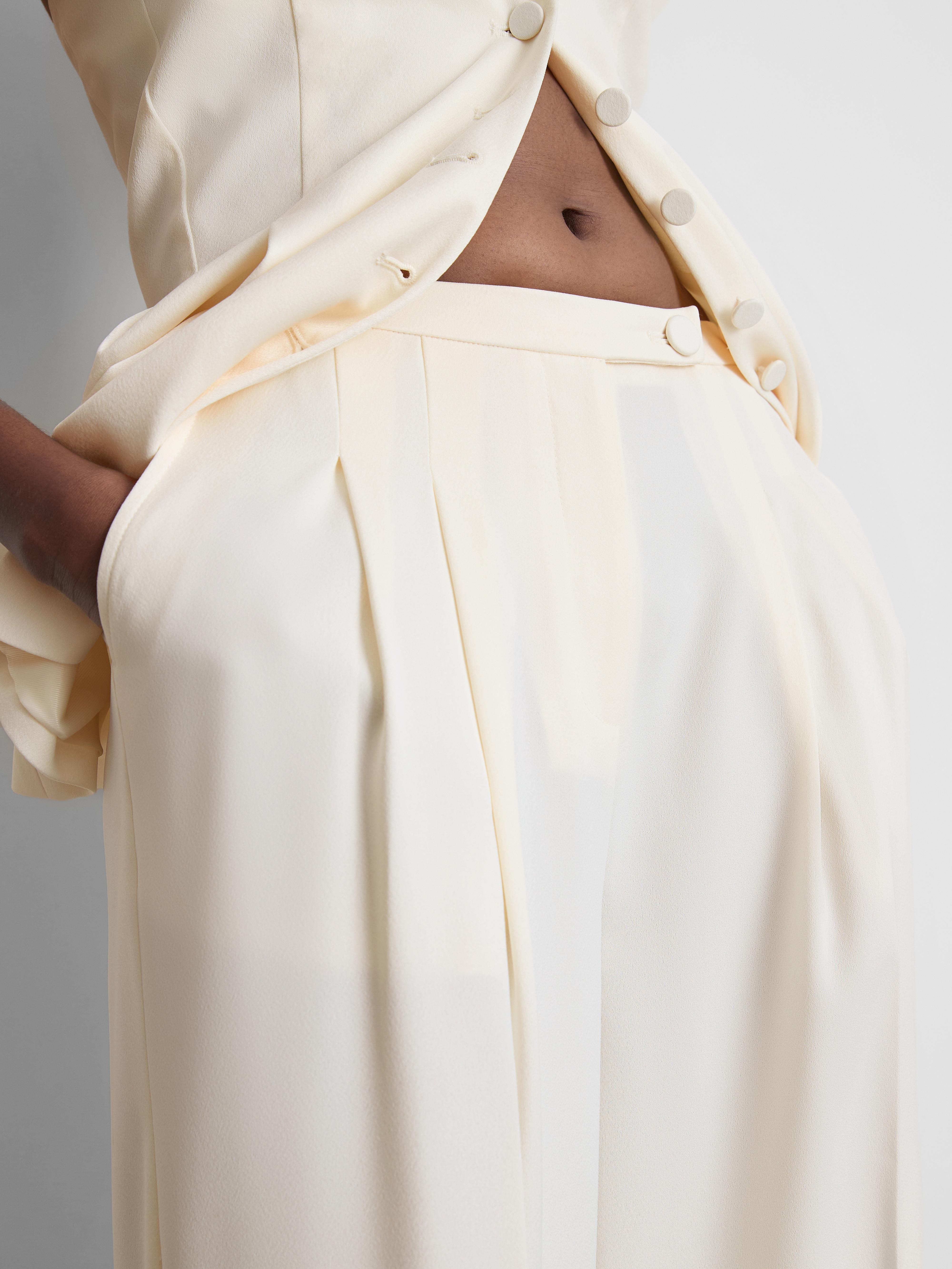 Pantalones de satén plisados de pernera ancha