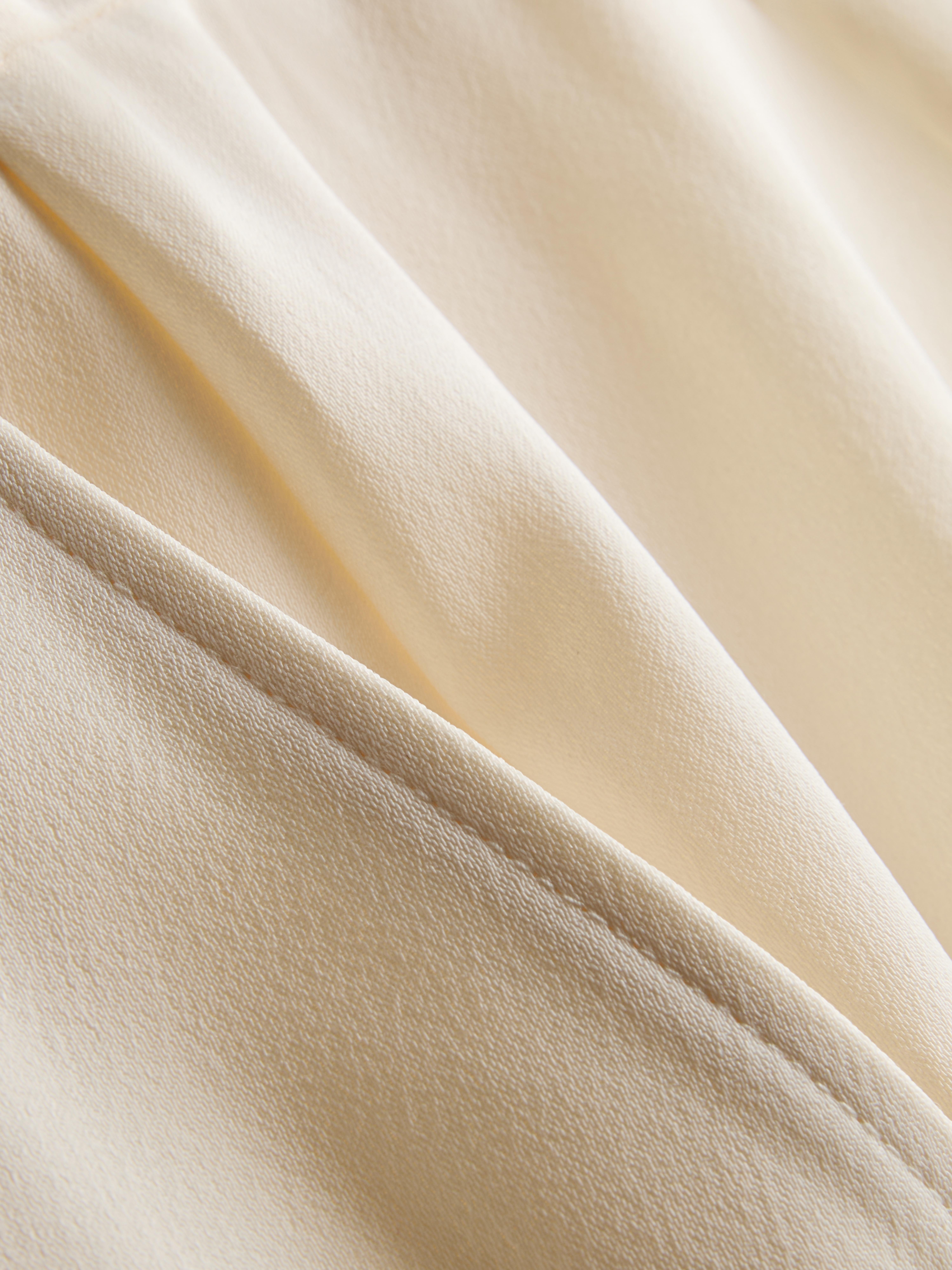 Pantalones de satén plisados de pernera ancha