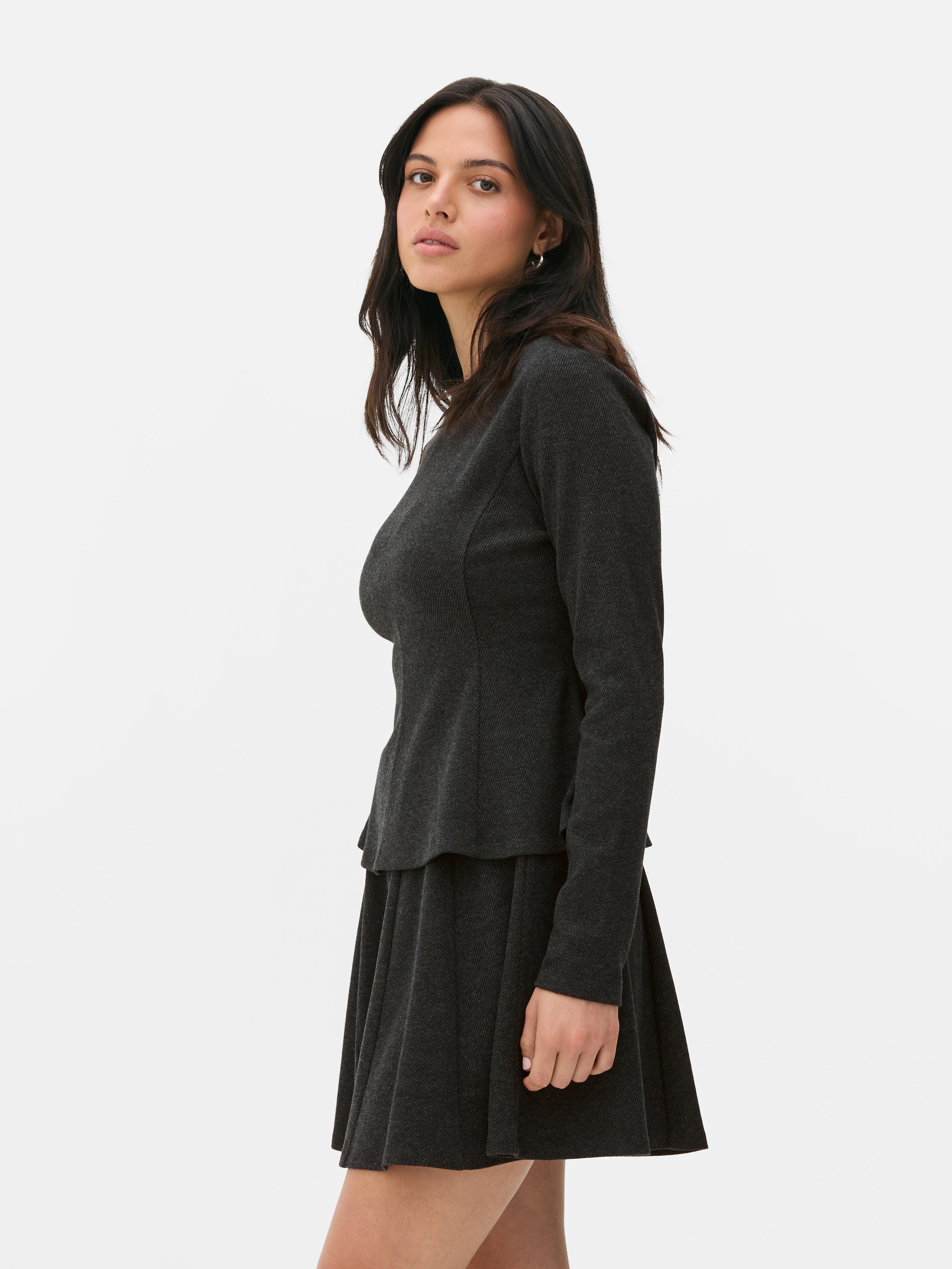 Top in peplum a maniche lunghe