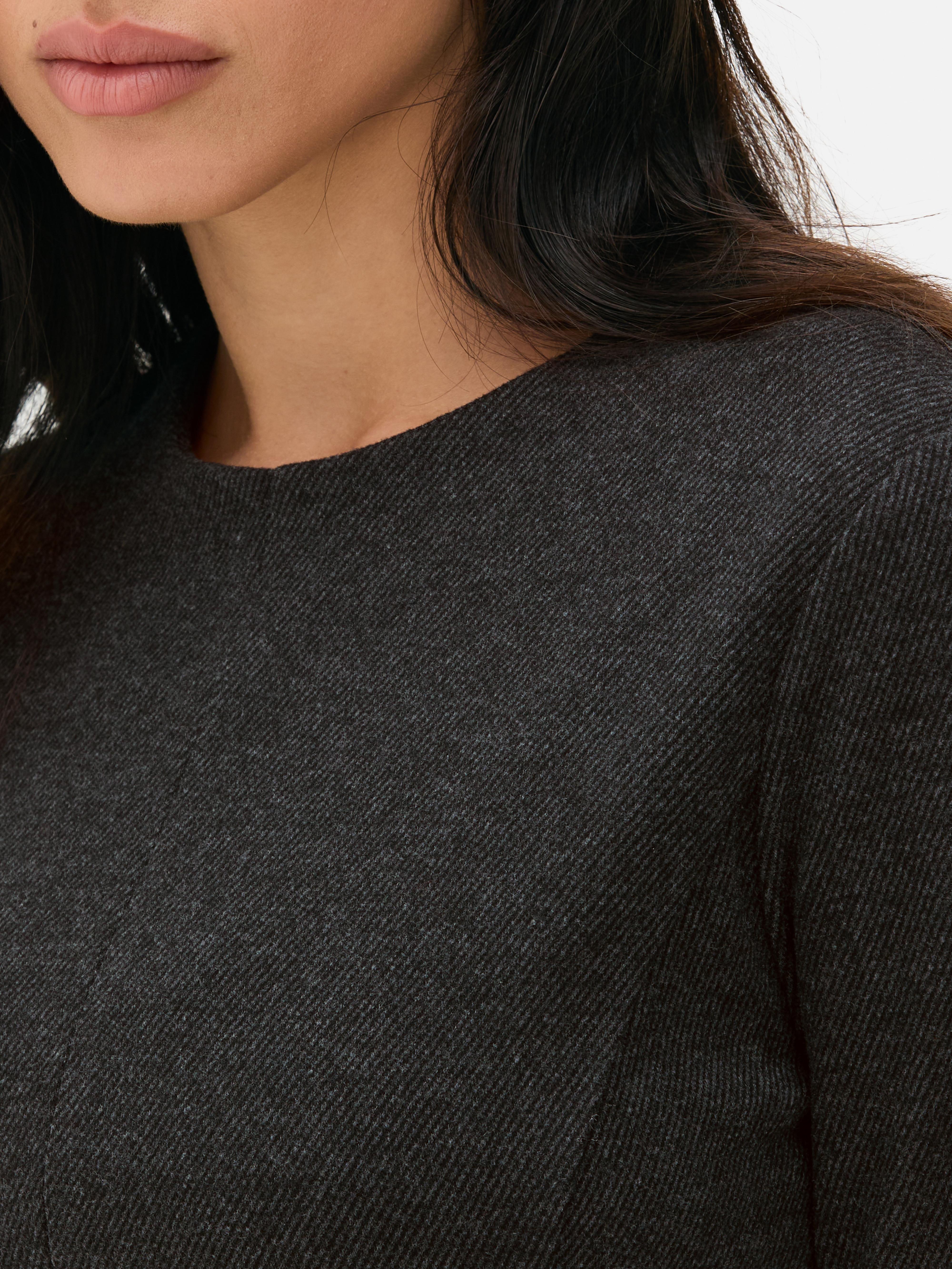 Top in peplum a maniche lunghe