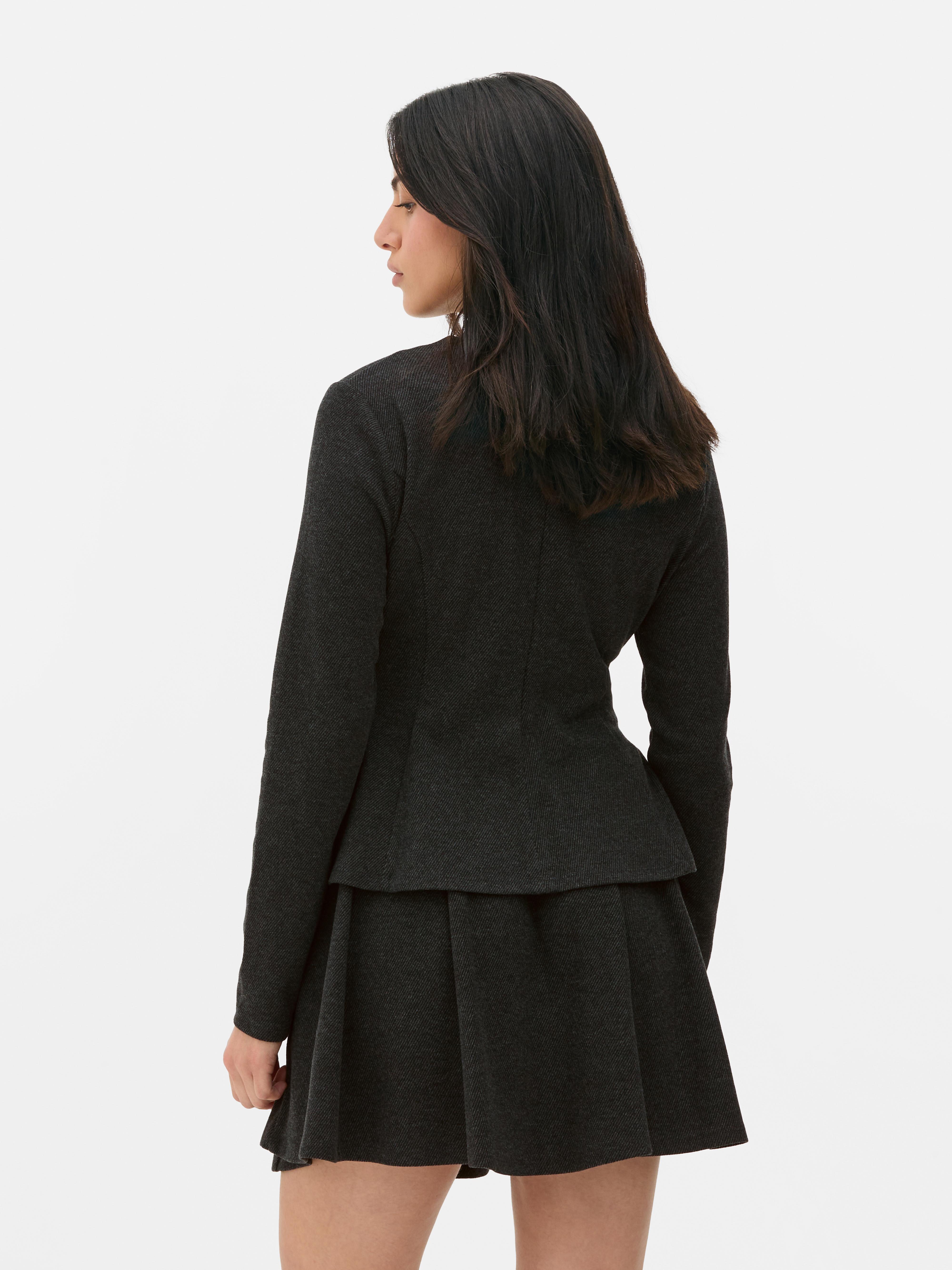 Top in peplum a maniche lunghe