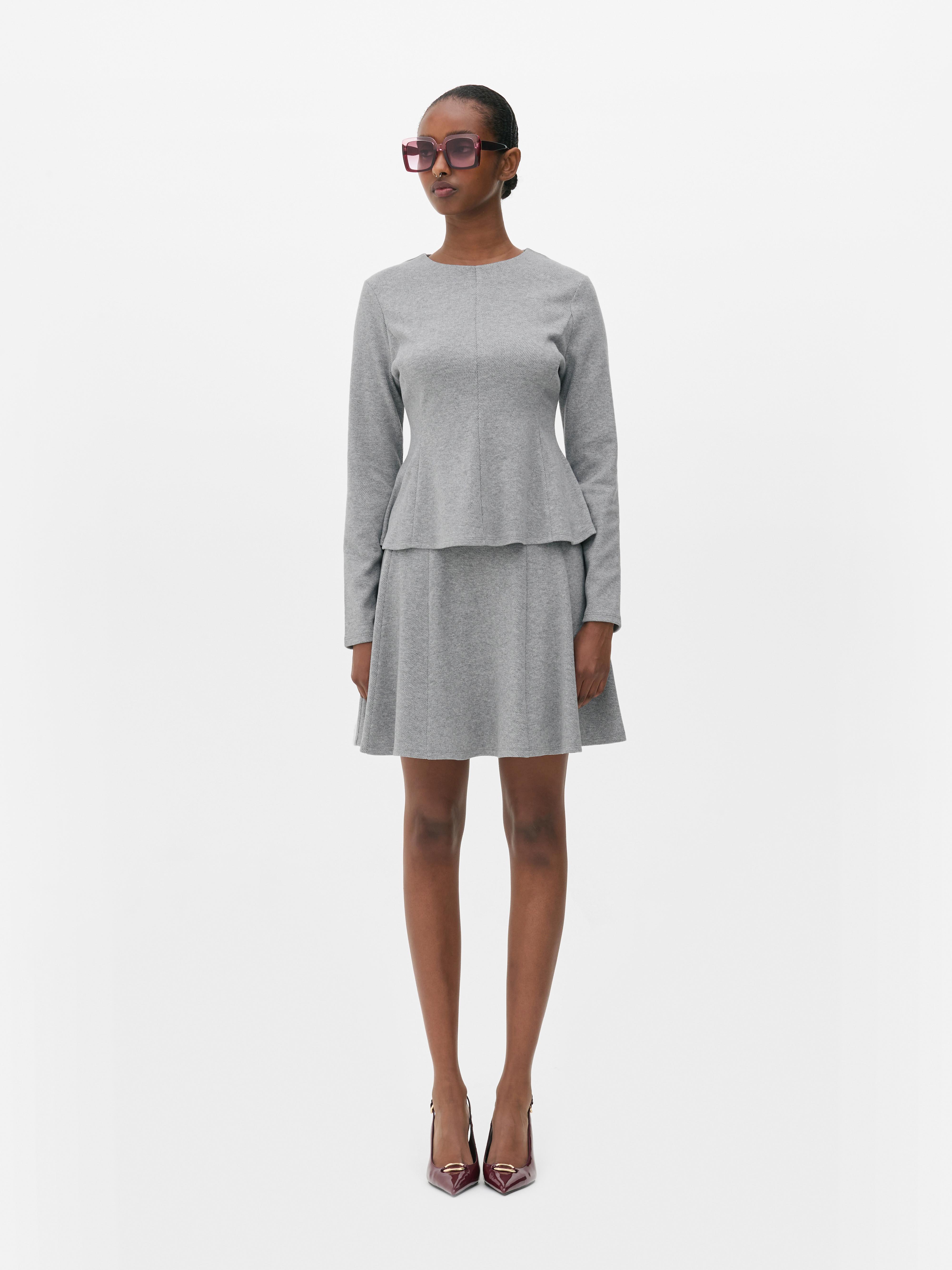 Top in peplum a maniche lunghe
