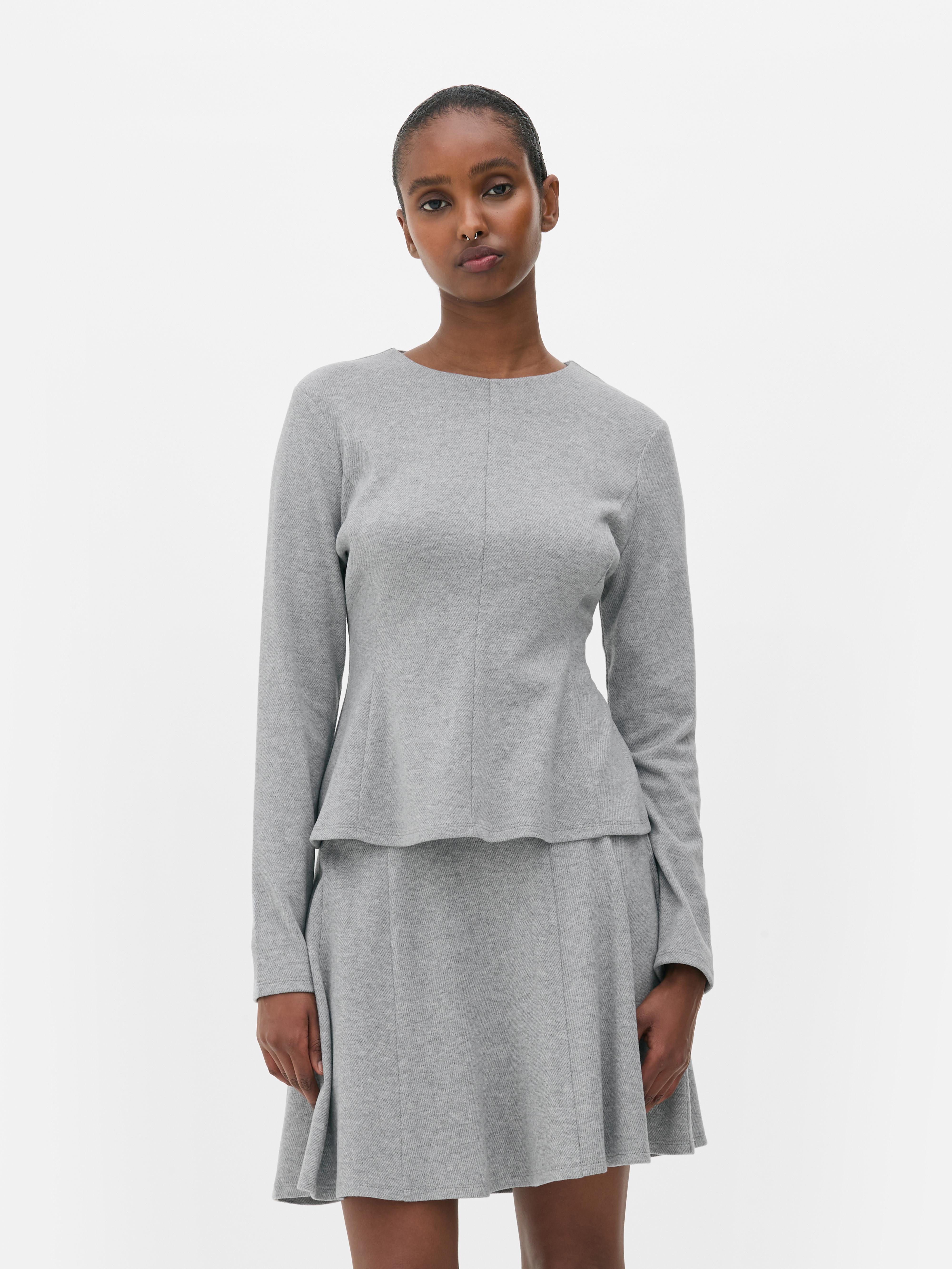 Top in peplum a maniche lunghe