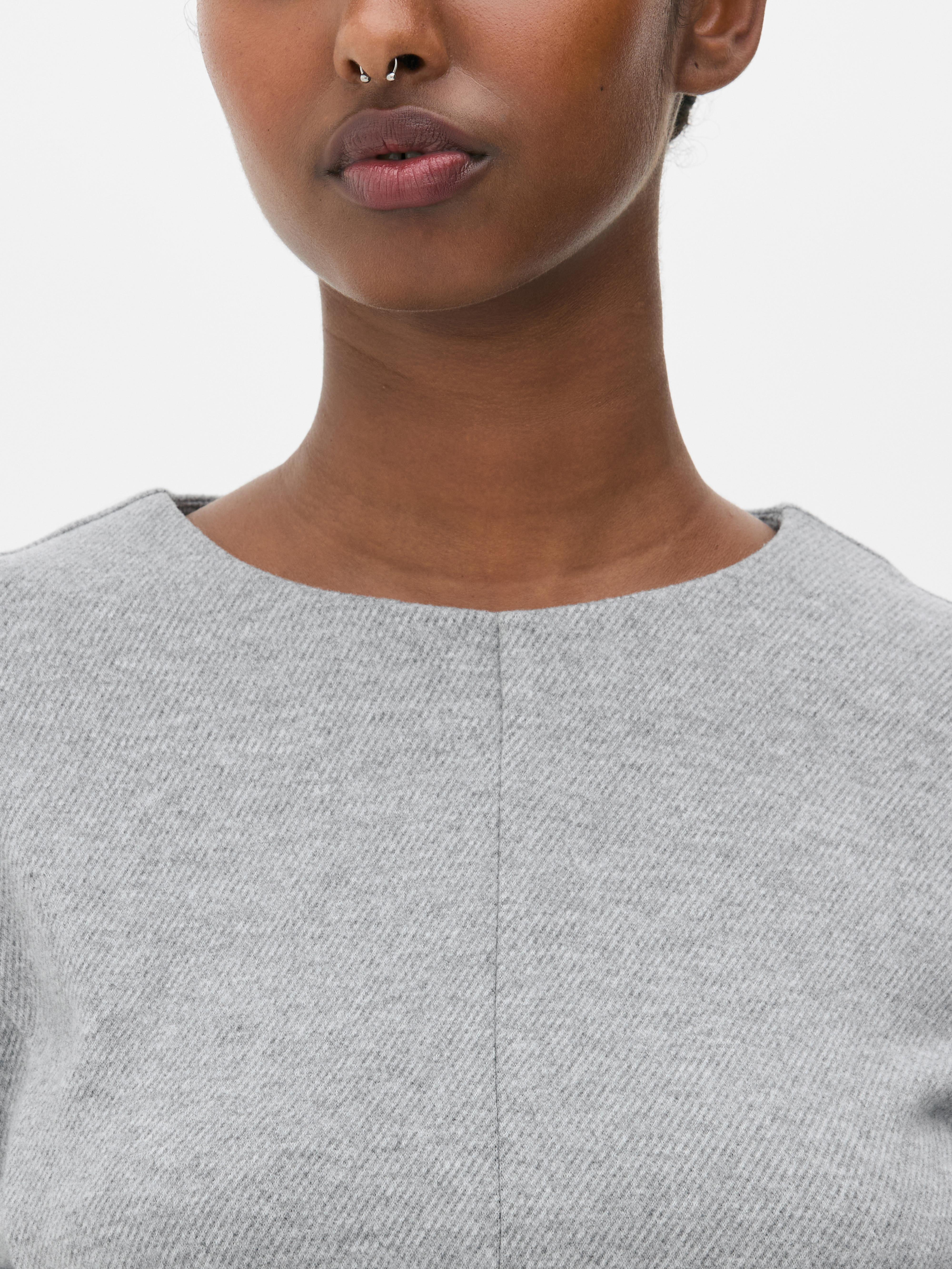 Top in peplum a maniche lunghe