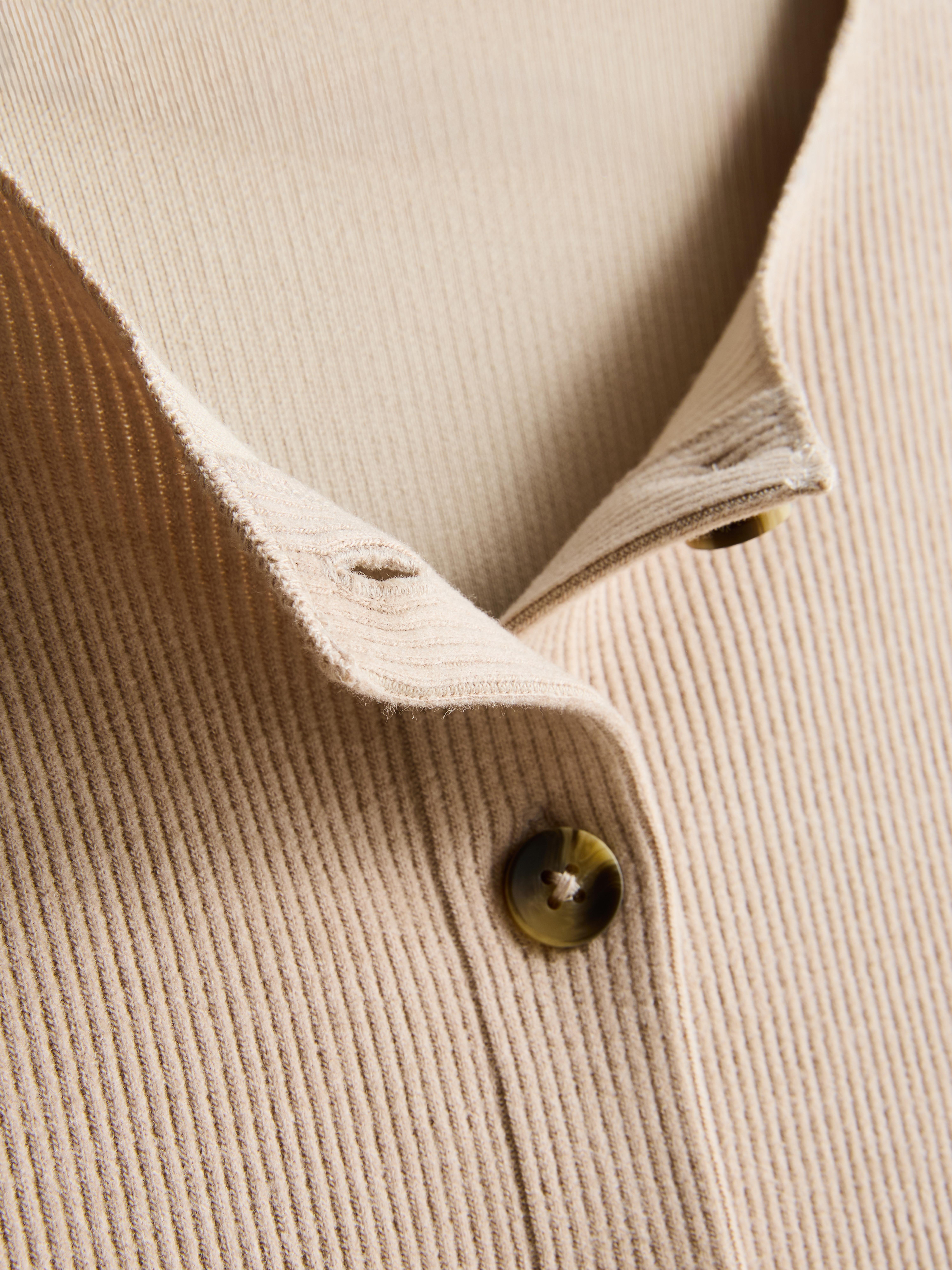 Casaco malha canelada gola redonda