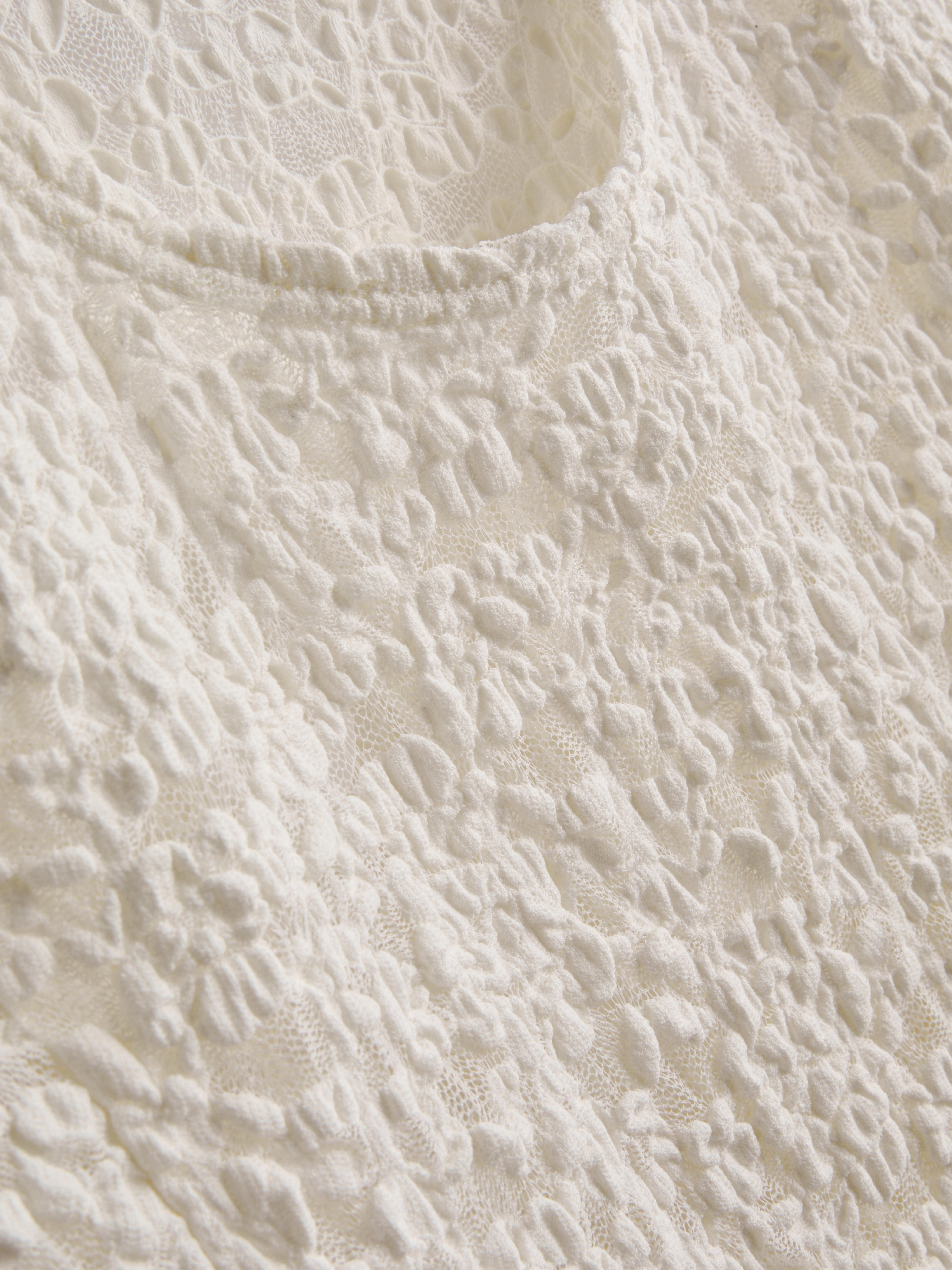 Asymmetrische top van katoenmix met kant en textuur