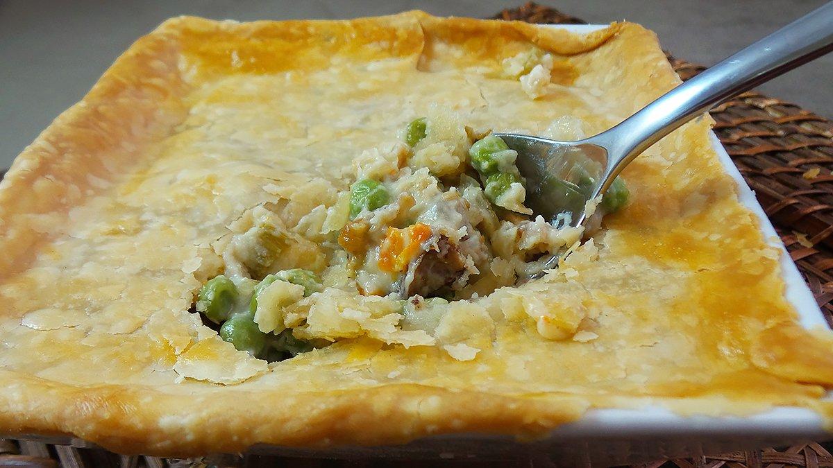 Top the pie with a flaky crust and bake till golden brown.