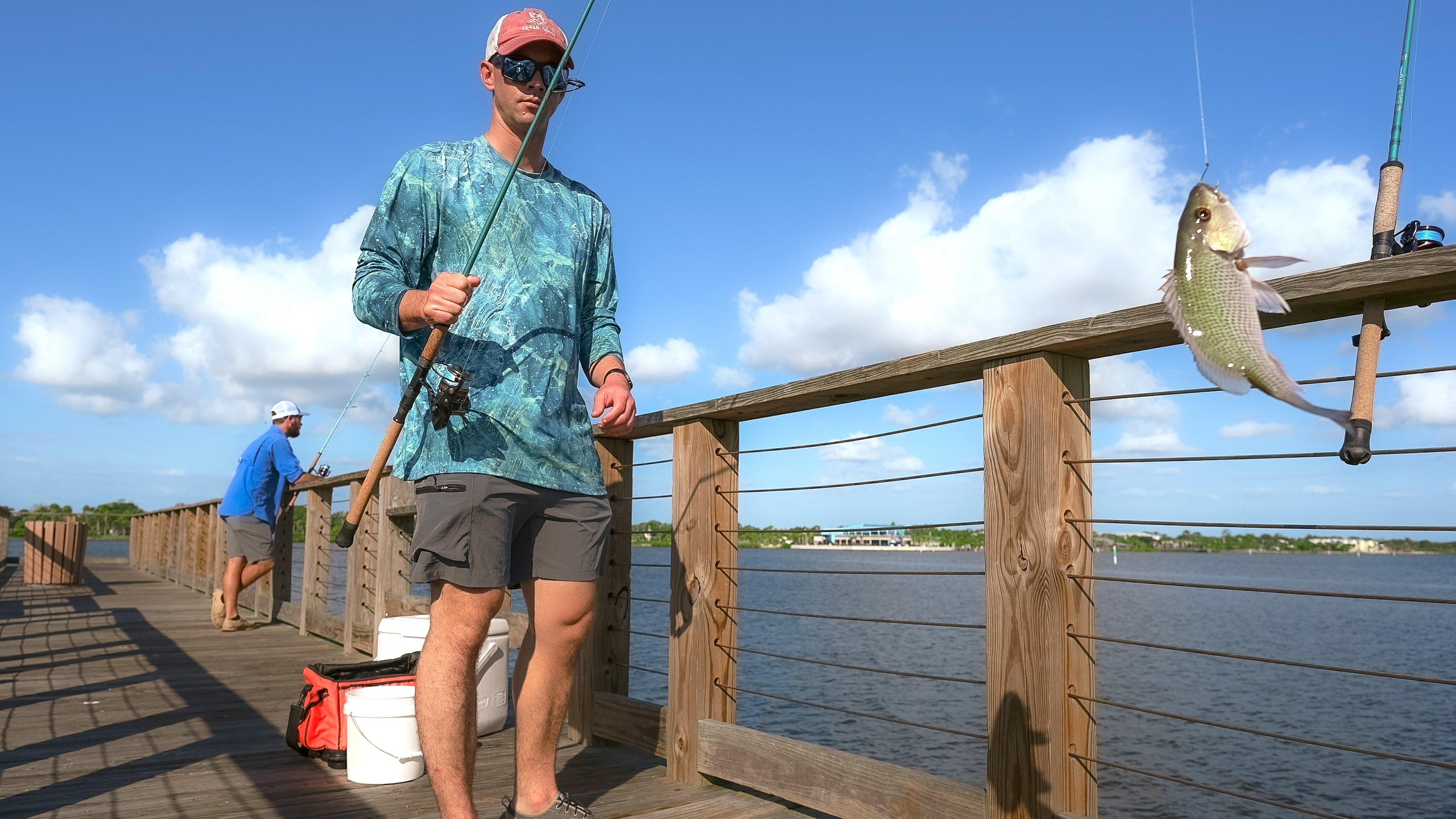 Red fishing on pier and on the boat. Fishing net and boats waiting