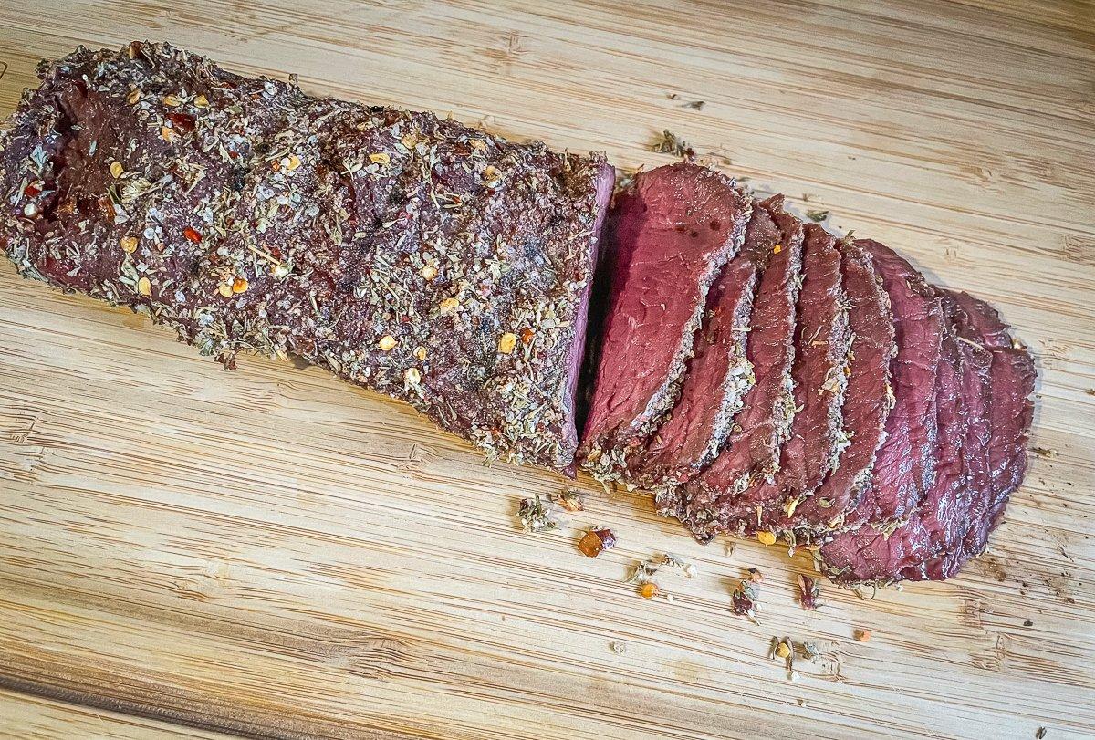 Grill the backstrap to your desired doneness and rest before slicing into thin strips.