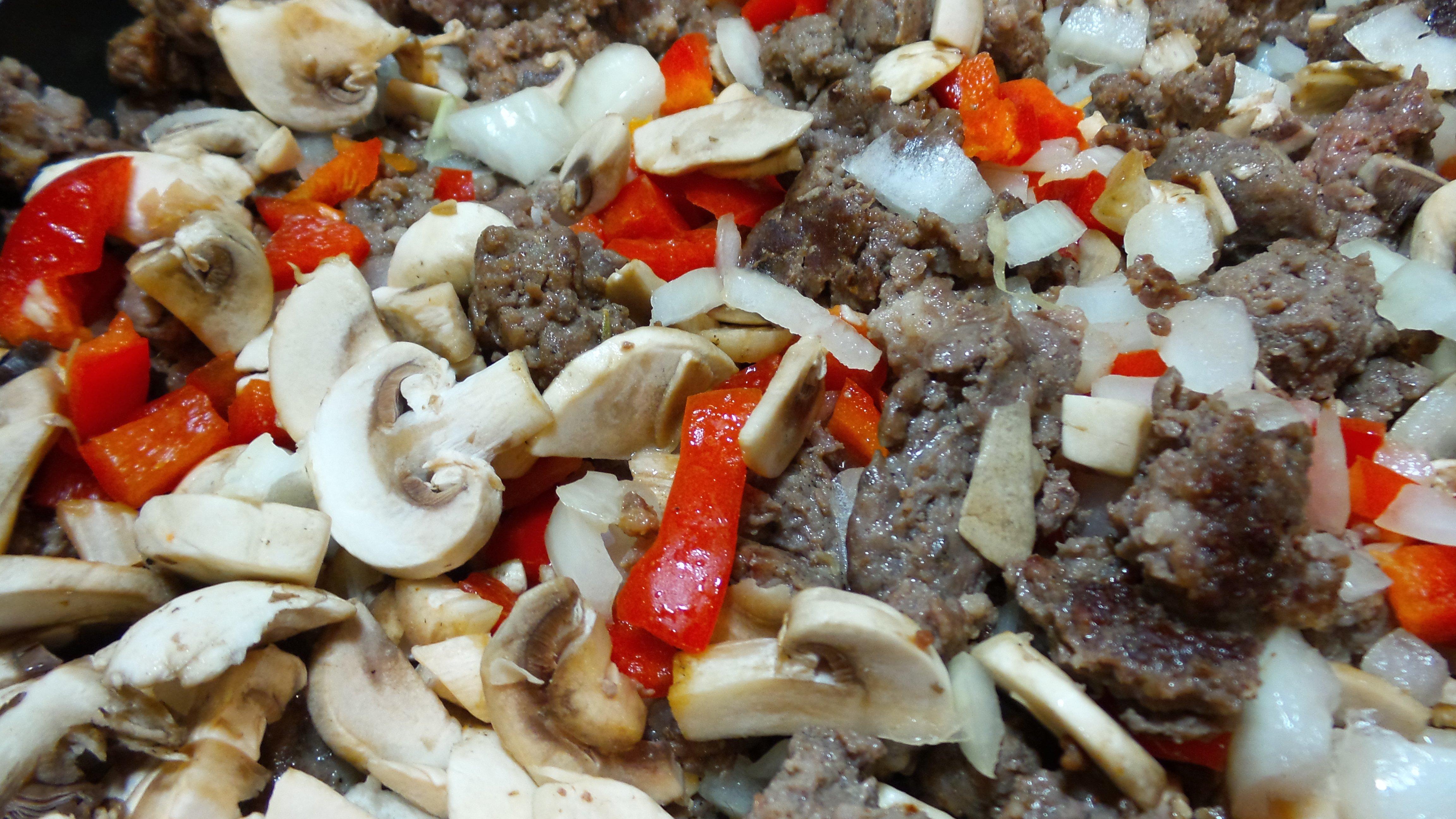Add the peppers, onions and mushrooms to the browned sausage.