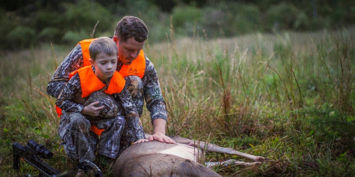 Bancroft and son with a deer from their hunt.