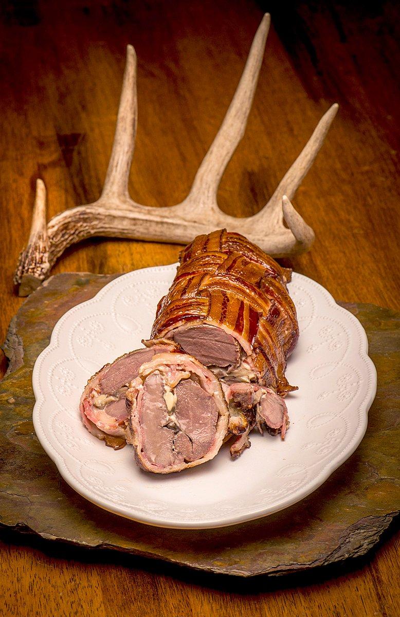 A bacon wrapped, blue cheese stuffed venison loin is a delicious alternative to supermarket beef or pork.©Bill Konway