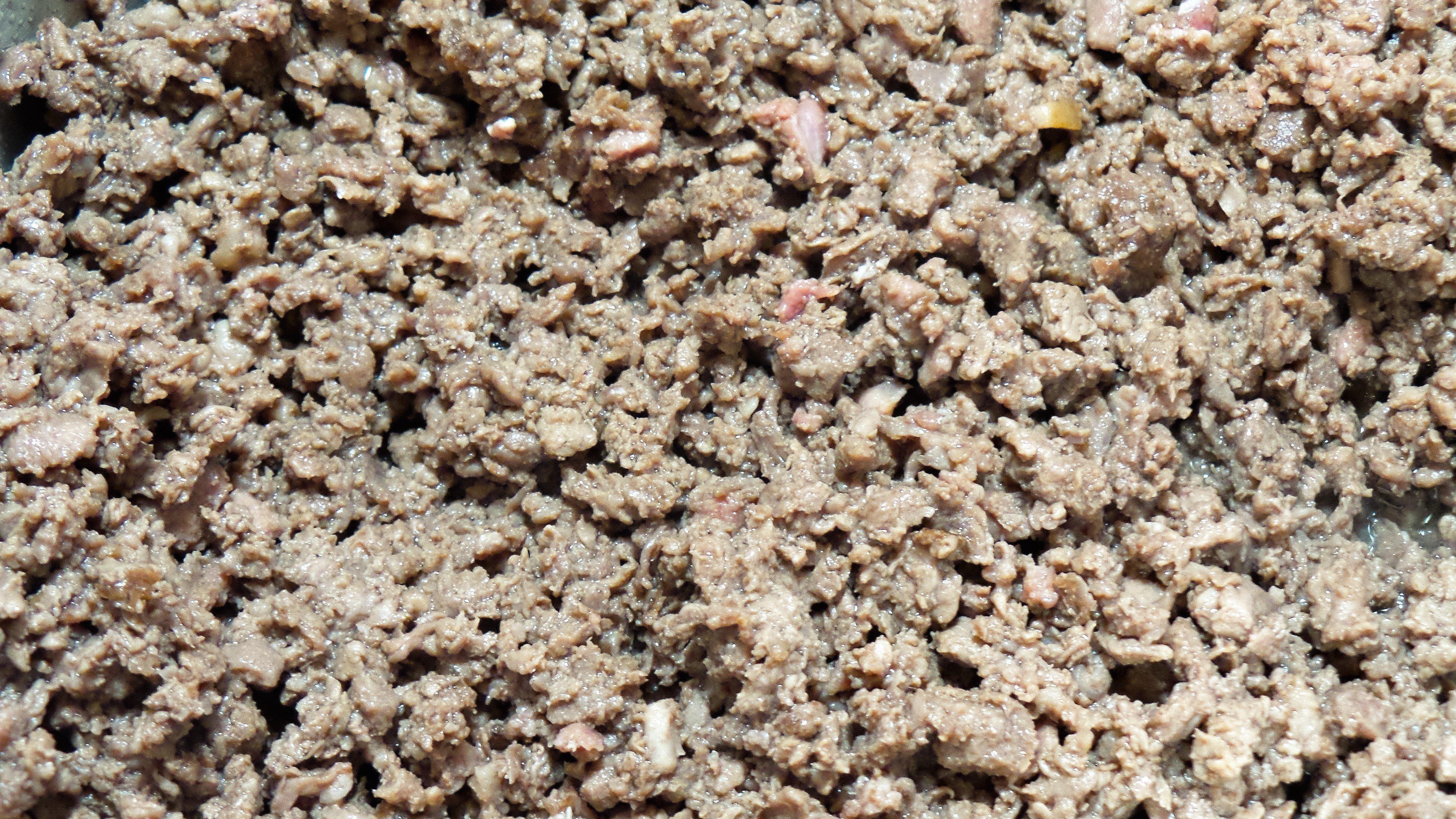 Brown the ground venison in a stock pot.