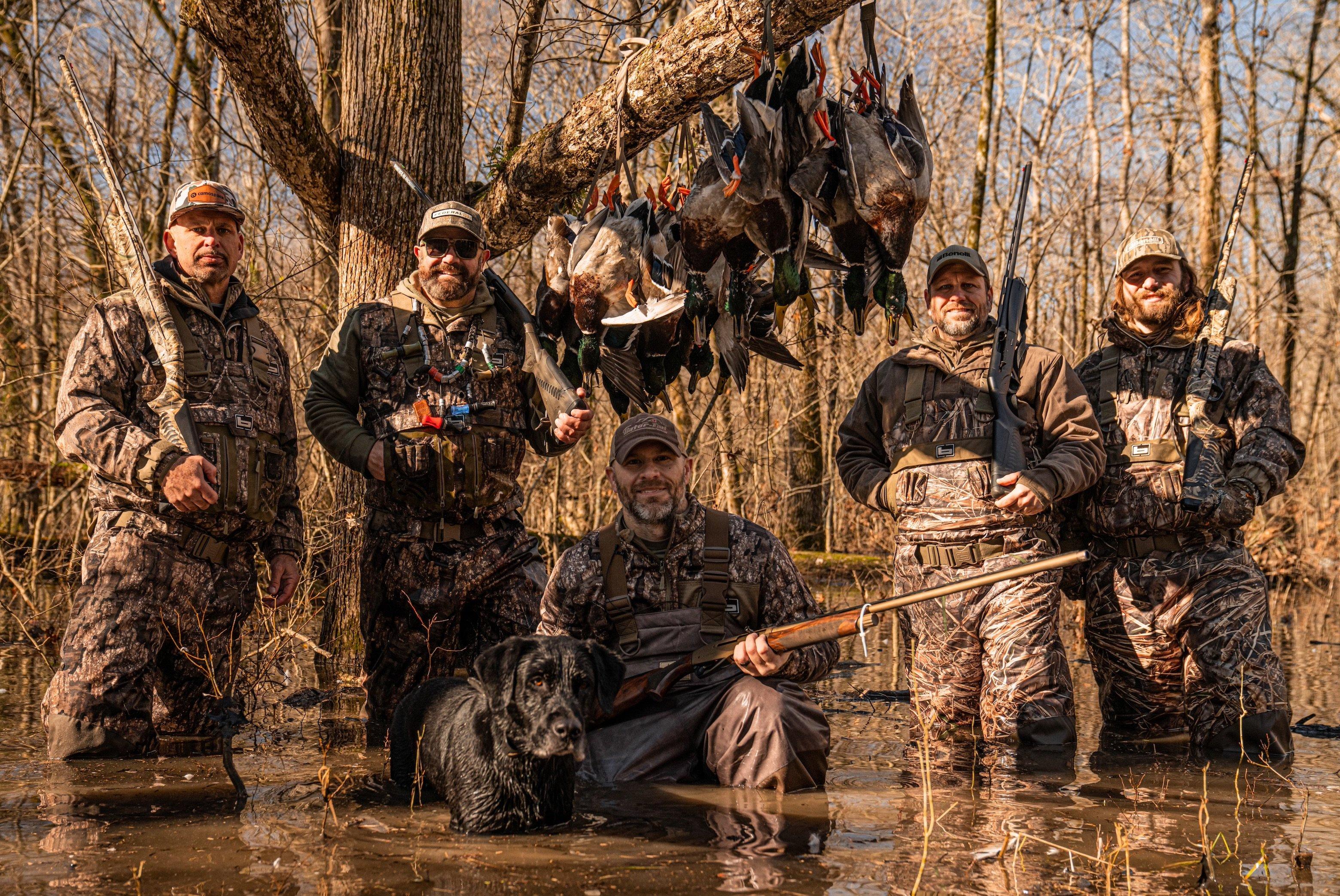 CamoSpace founder Denny Reid (left) with Chad Belding and buddies following a good flooded timber duck hunt. 