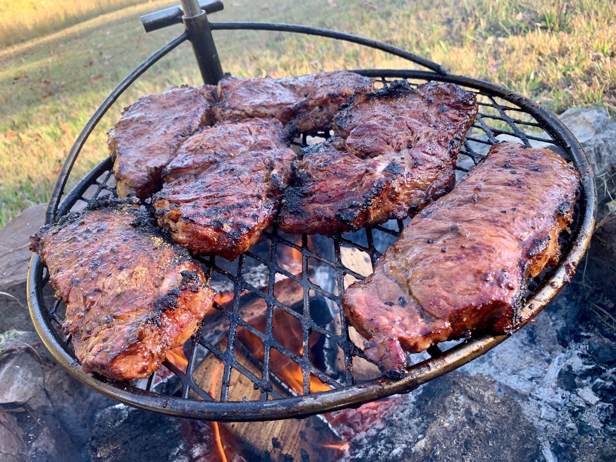 Use an adjustable height grill to make temperature adjustment over an open flame easy.