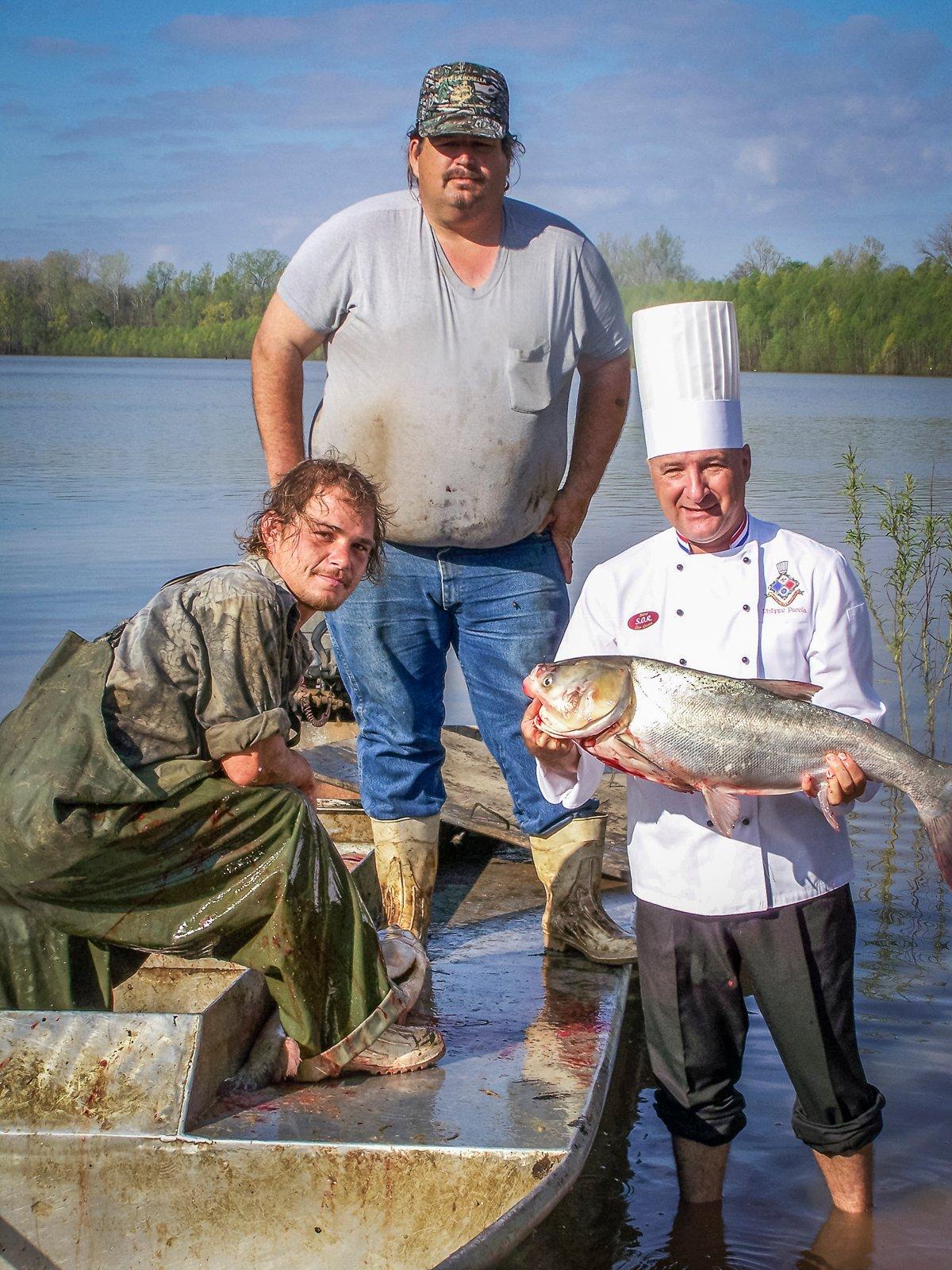 Chef Philippe with an invasive carp straight from the fishermen. Photo by Chef Philippe