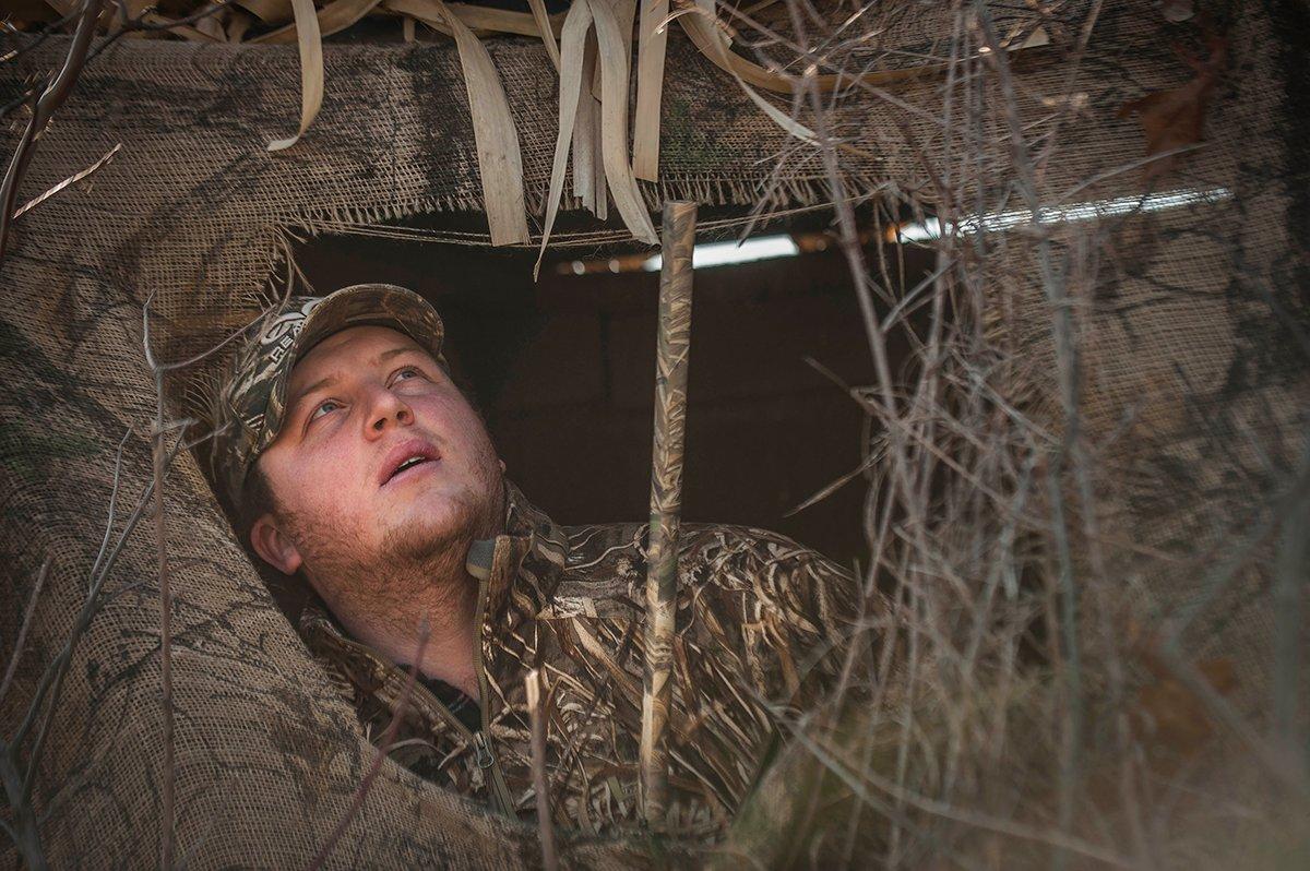 Your face can shine like a spotlight to wary ducks and geese. Keep your head down, and wear camo or face paint. Photo © Bill Konway