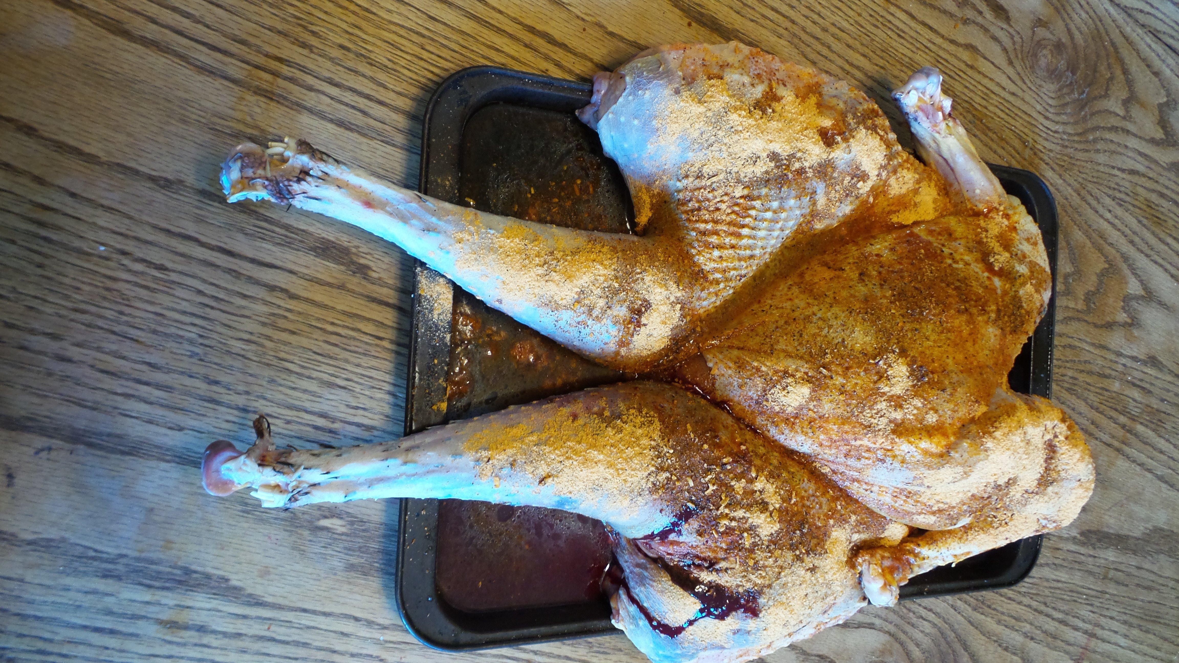 Rub the spatchcocked bird with olive oil and coat with your favorite BBQ rub.