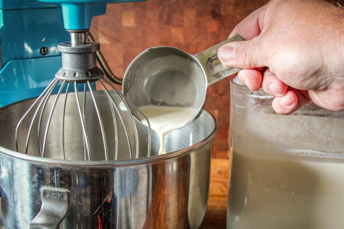 Scoop the cream from the milk and add it to the bowl of your mixer.