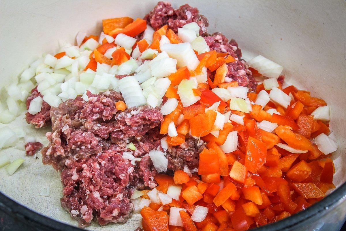 Start by browning the ground venison with the chopped bell pepper and onion.