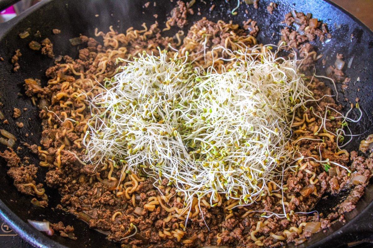 Once the noodles have cooked, add the sprouts.