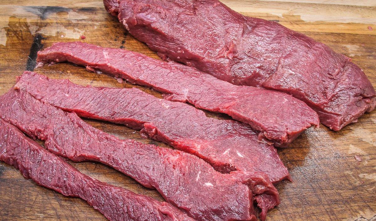 Slice the backstrap into long, thin strips.