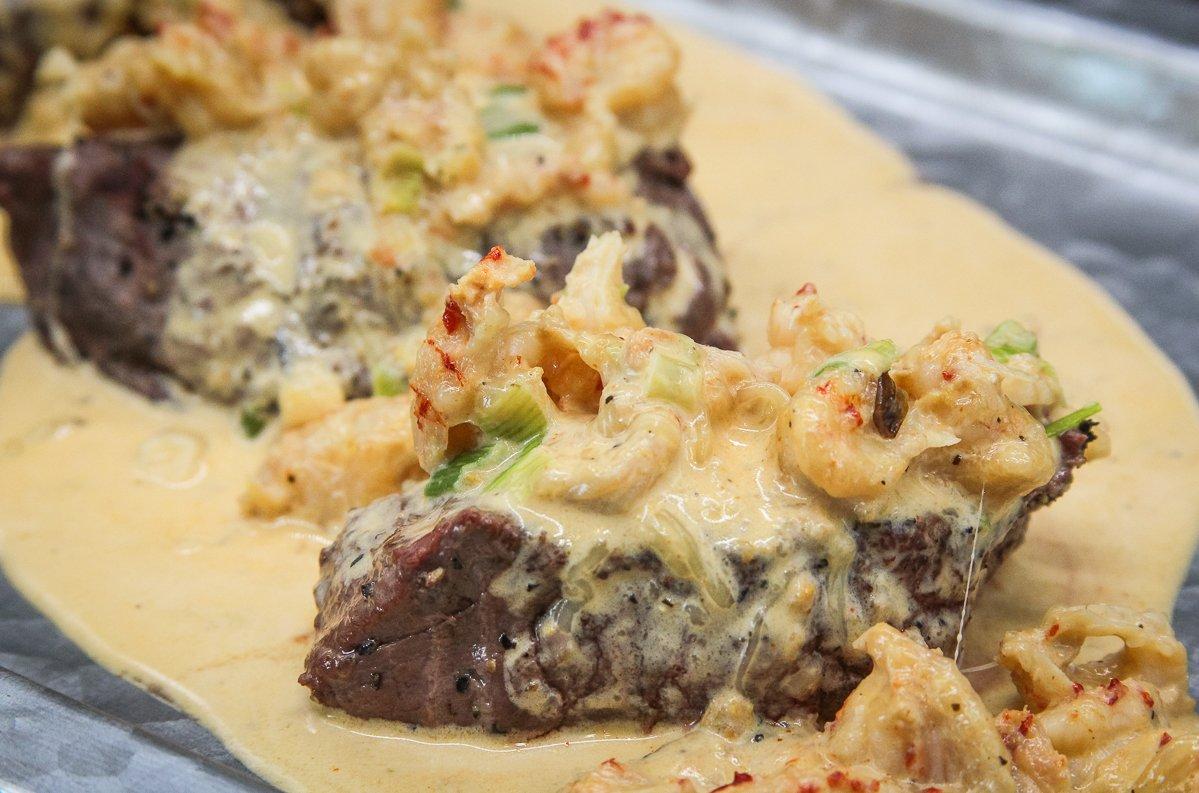 Top grilled backstrap with creamy crawfish sauce for a fresh take on surf and turf.