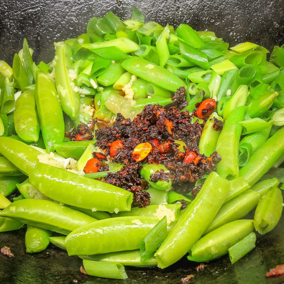 Add the snap peas and the chili flakes.