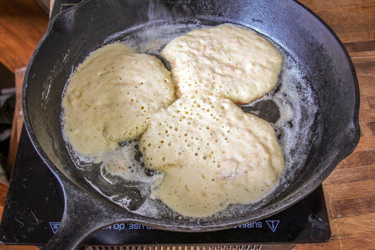 I like a cast iron skillet or griddle and melted butter for cooking pancakes.