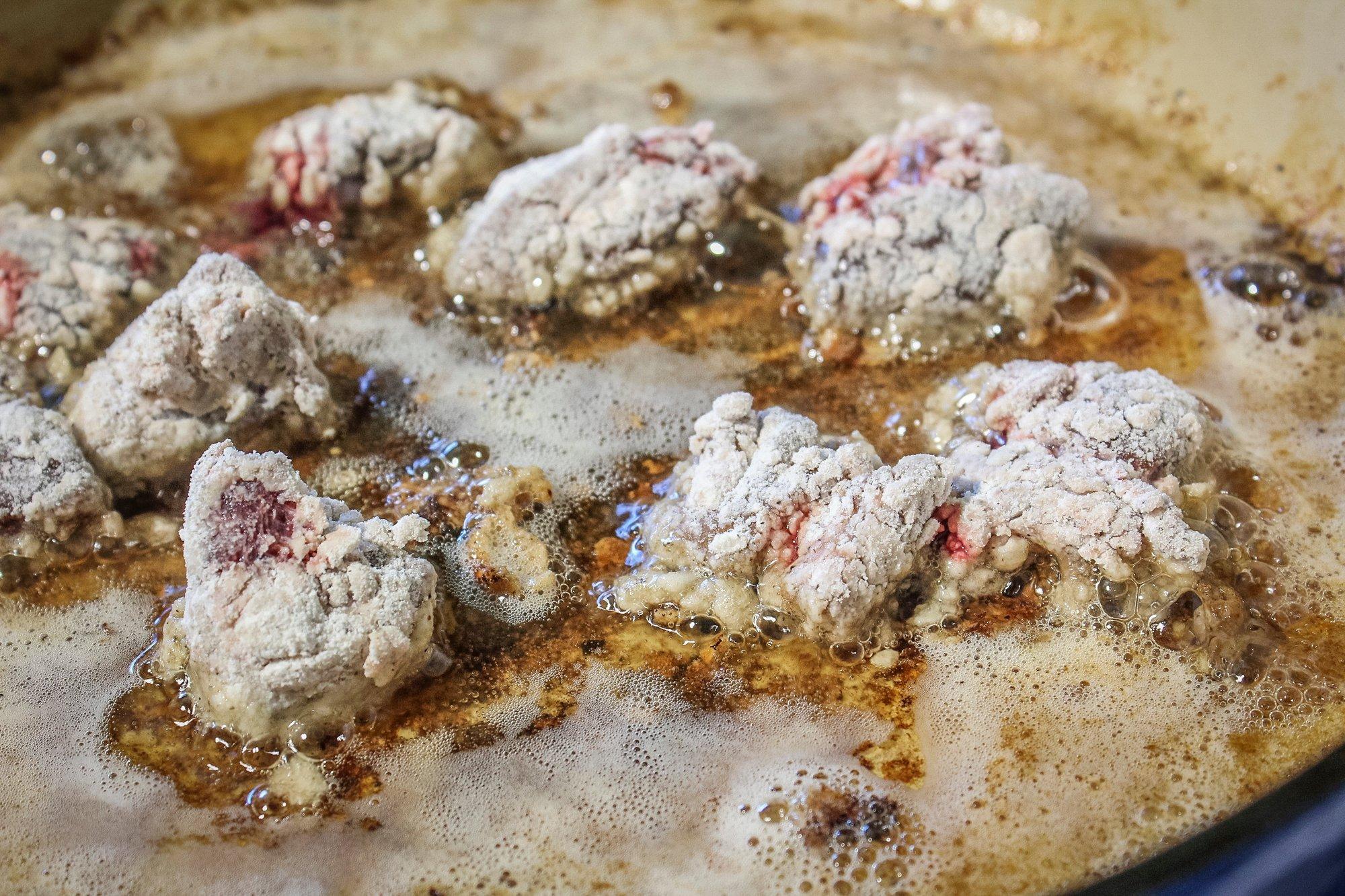 Fry the dredged livers in the bacon grease for three to five minutes per side.