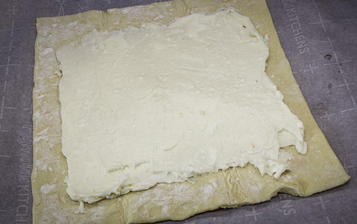 Spread the sweetened cream cheese over the puff pastry.