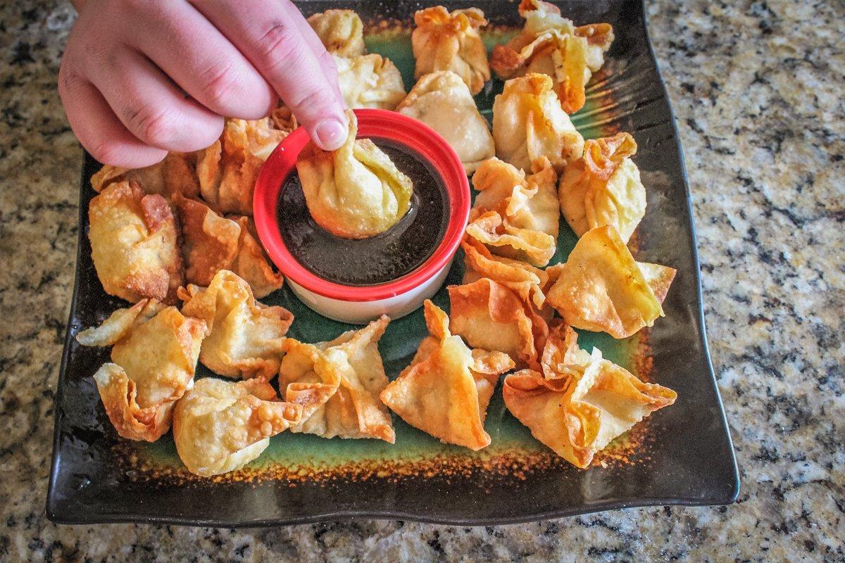 Serve the rangoons with the salty and sweet dipping sauce.
