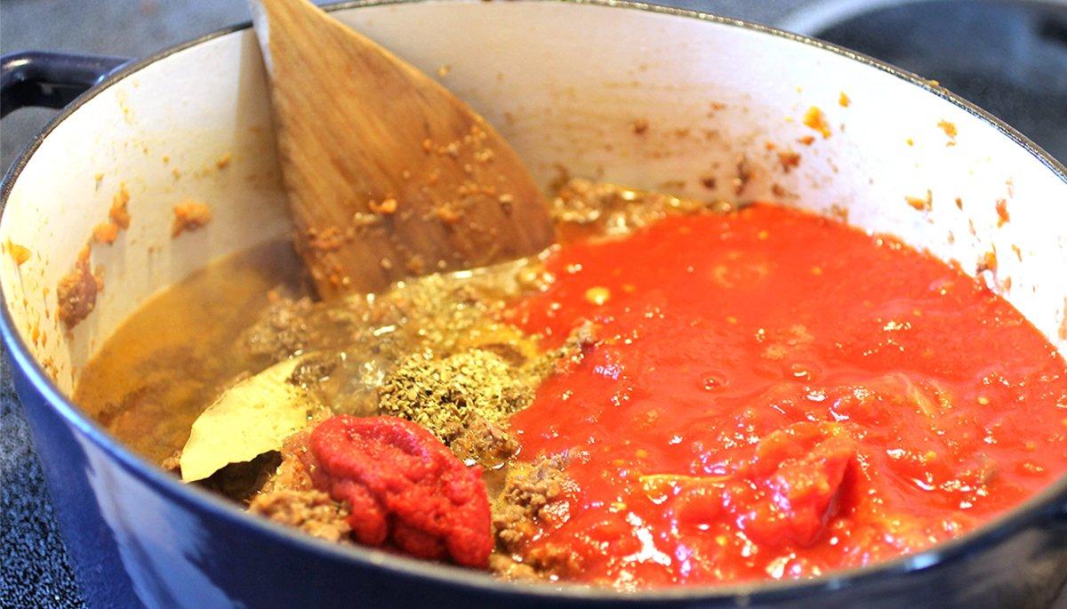 Add the ingredients to a heavy pot and simmer for a minimum of two hours. The longer the cook time, the better the sauce.