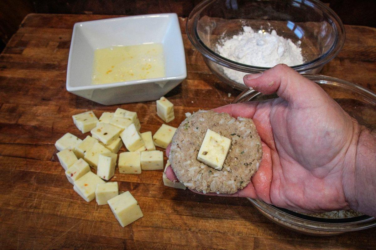 Make a flat boudin patty and place on a block of cheese.
