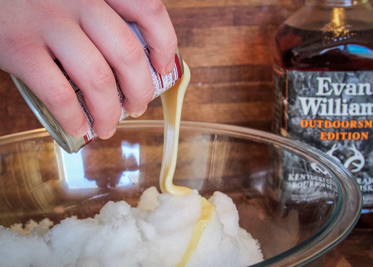 Add the sweetened condensed milk to the snow.