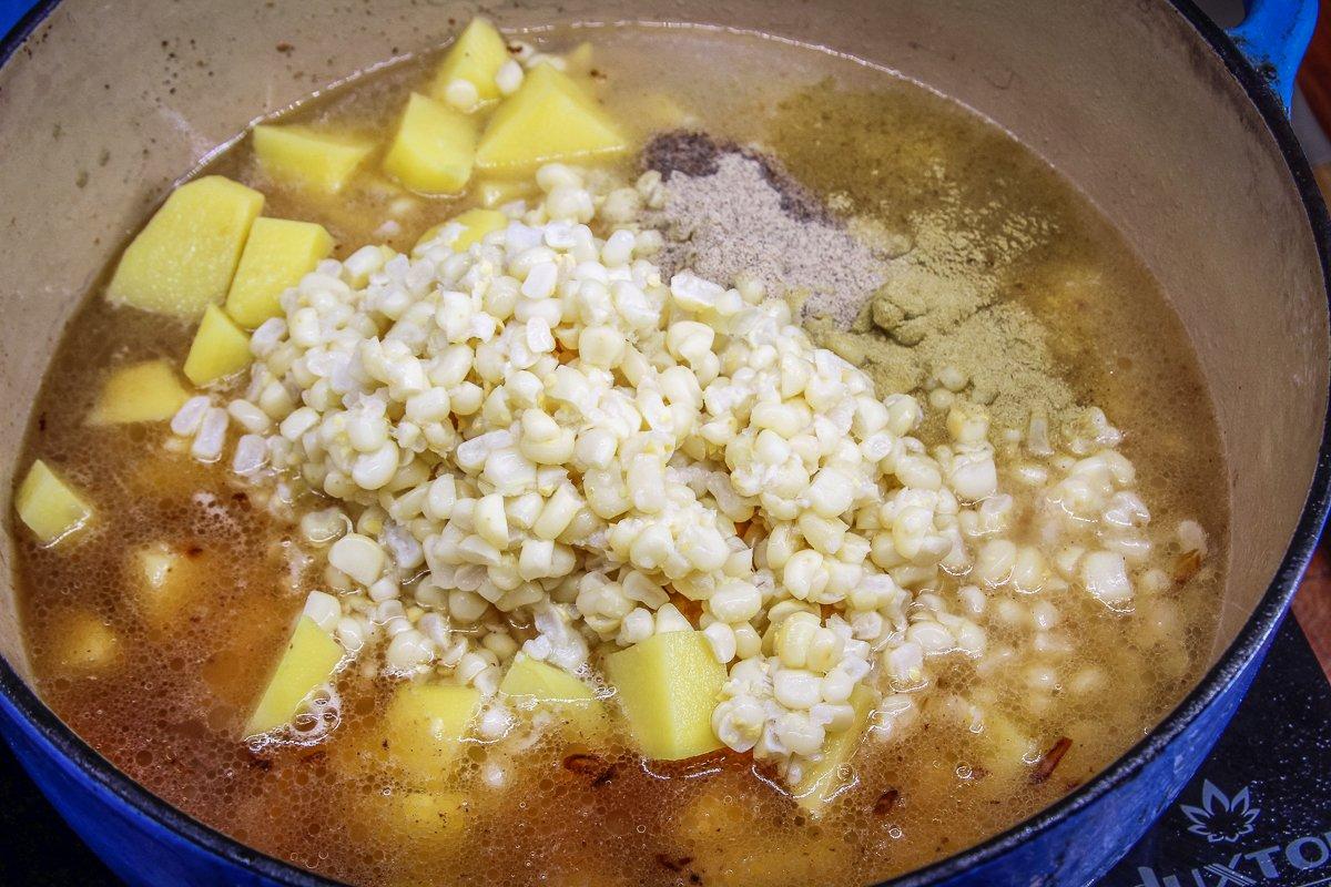 Boil the potatoes, onions, corn, and seasonings for a while before adding the fish and cream.