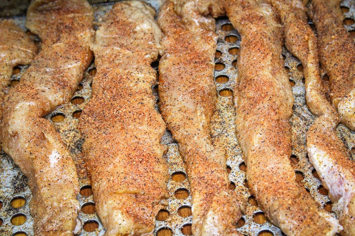 Sprinkle the marinated fish with your favorite Cajun seasoning.