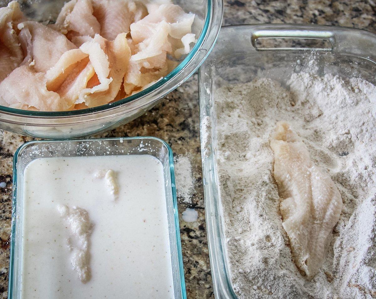 Dip the catfish fillets into the buttermilk, then into the seasoned corn meal mixture.