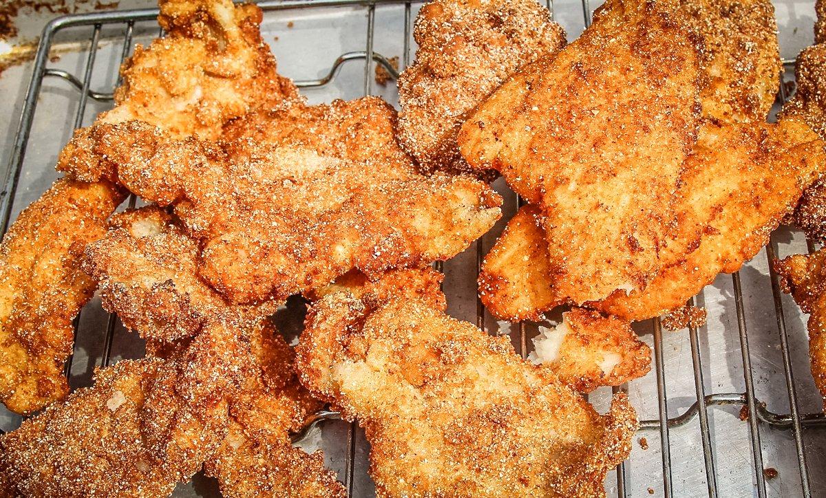 Drain the crispy catfish on a wire rack while you continue frying the next batch.