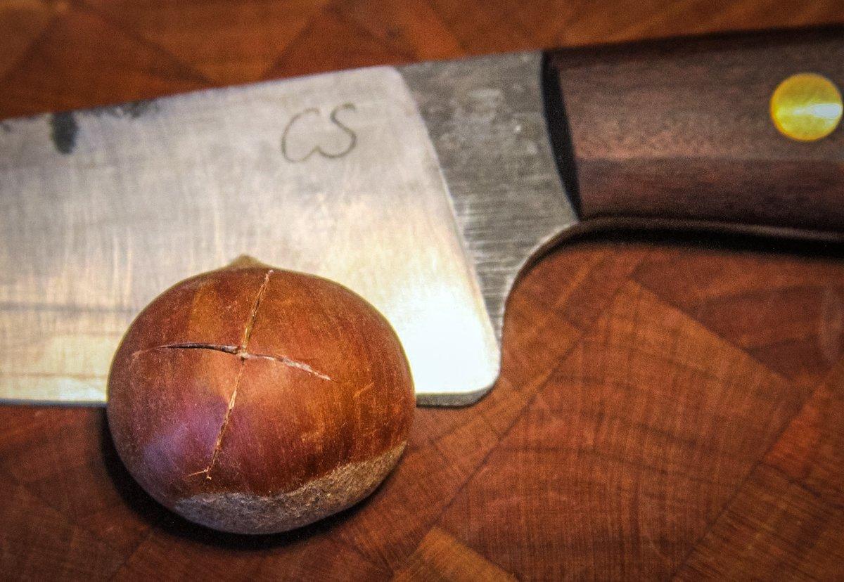 A shallow cross cut with a sharp knife allows steam to escape as the nuts roast.