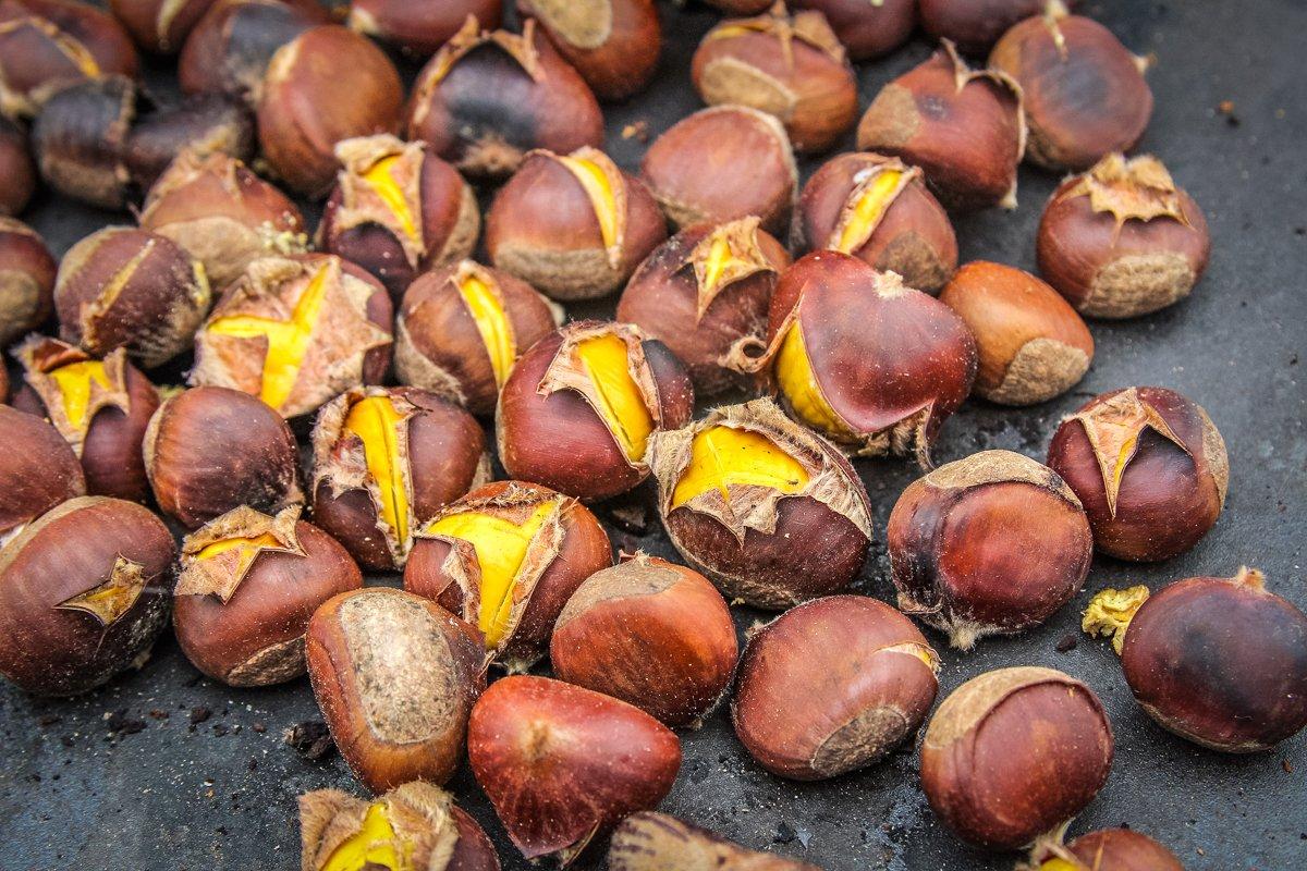 As the chestnuts roast, the skin will pop open at the score.