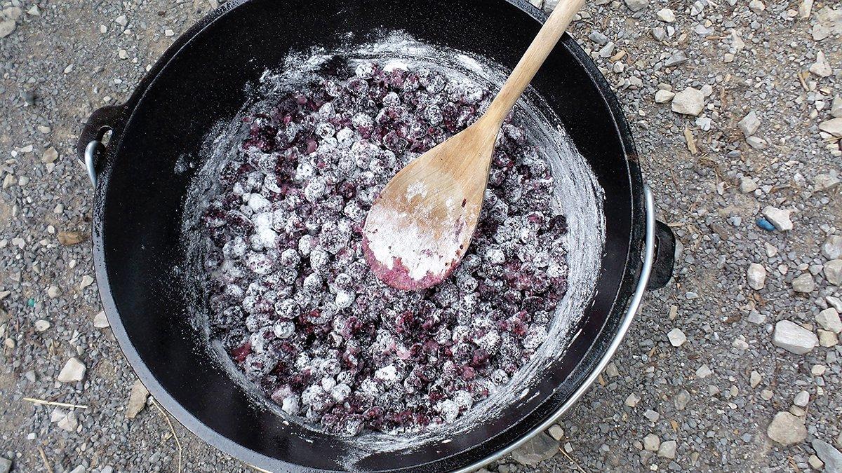 Mix the sugar and flour into the berries, then give them a gentle stir before topping with the remaining ingredients.