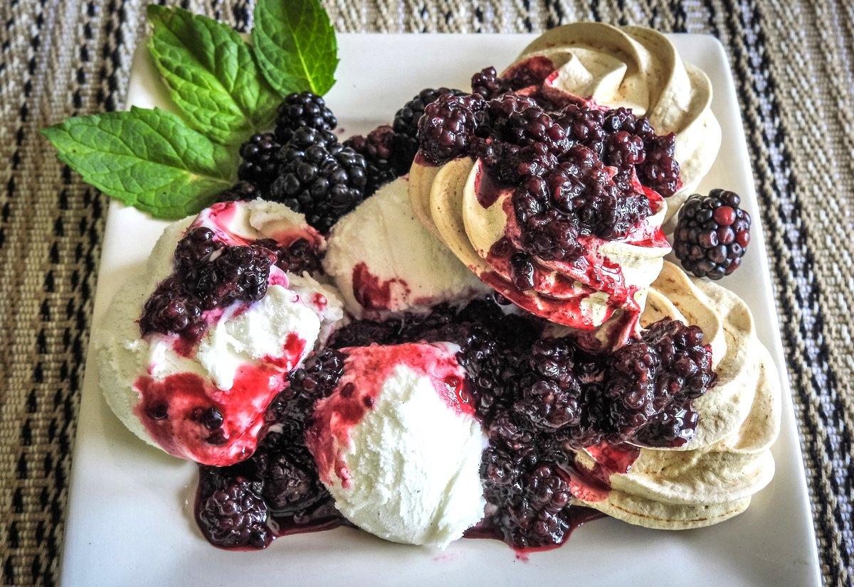 Plate the dessert by serving the cookies alongside ice cream with compote spooned over the top of both.