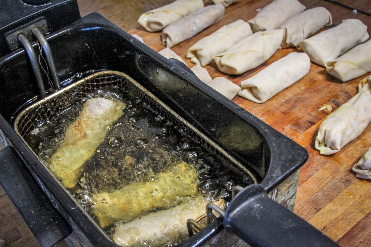 Deep fry the egg rolls in batches until crisp and golden brown.