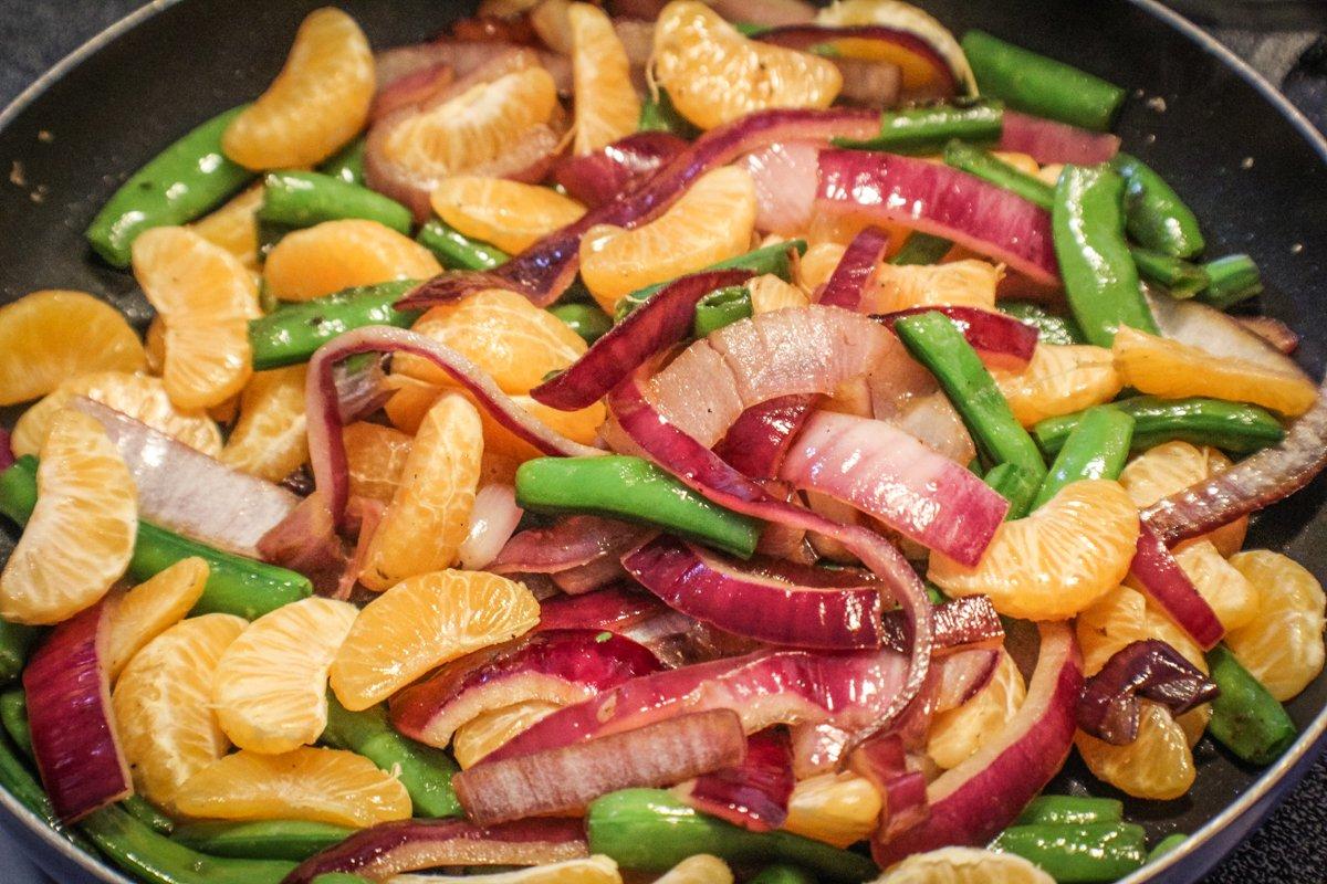 The sweet tangerine slices pair well with the crunchy onions and snap peas.