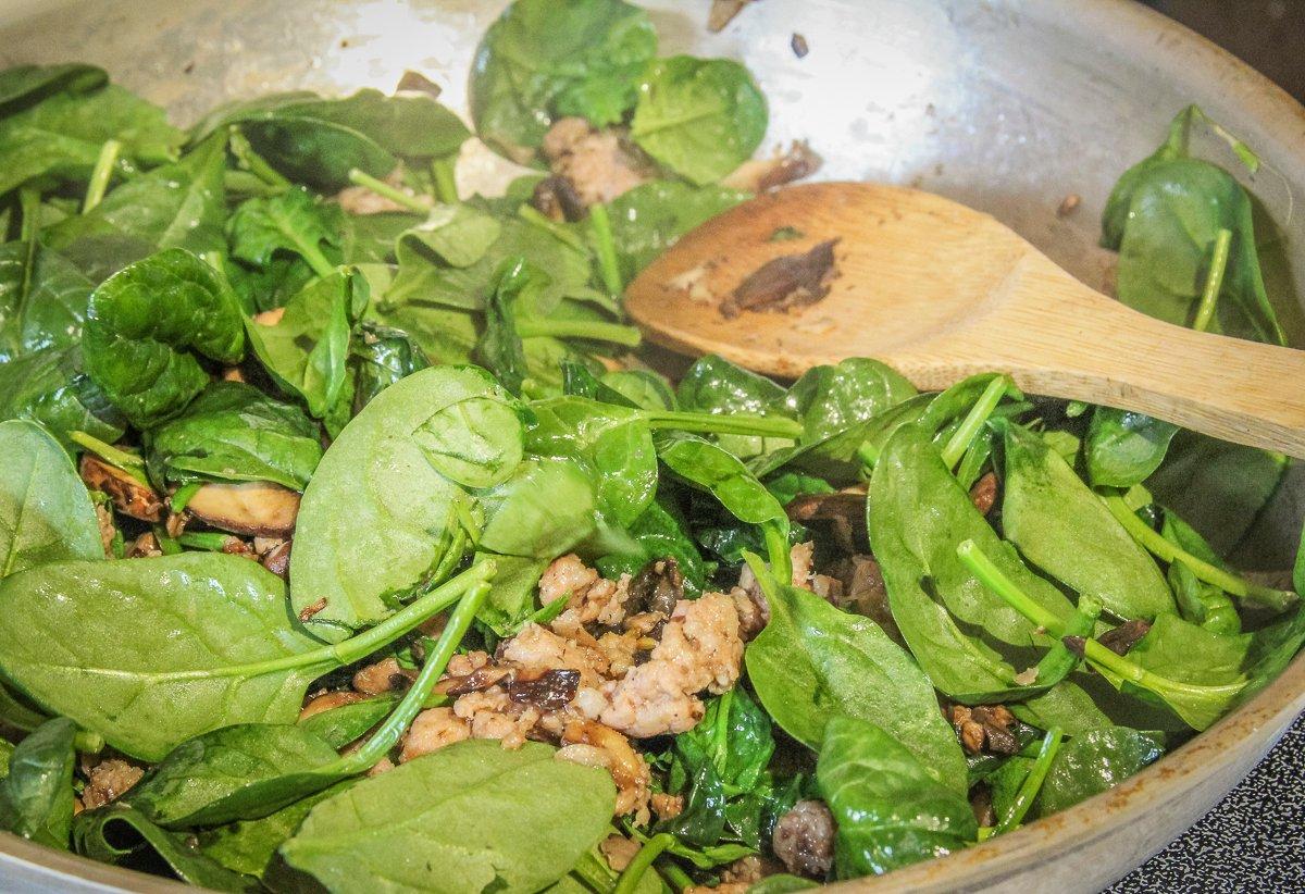 Brown the sausage and mushrooms, then stir in the spinach.
