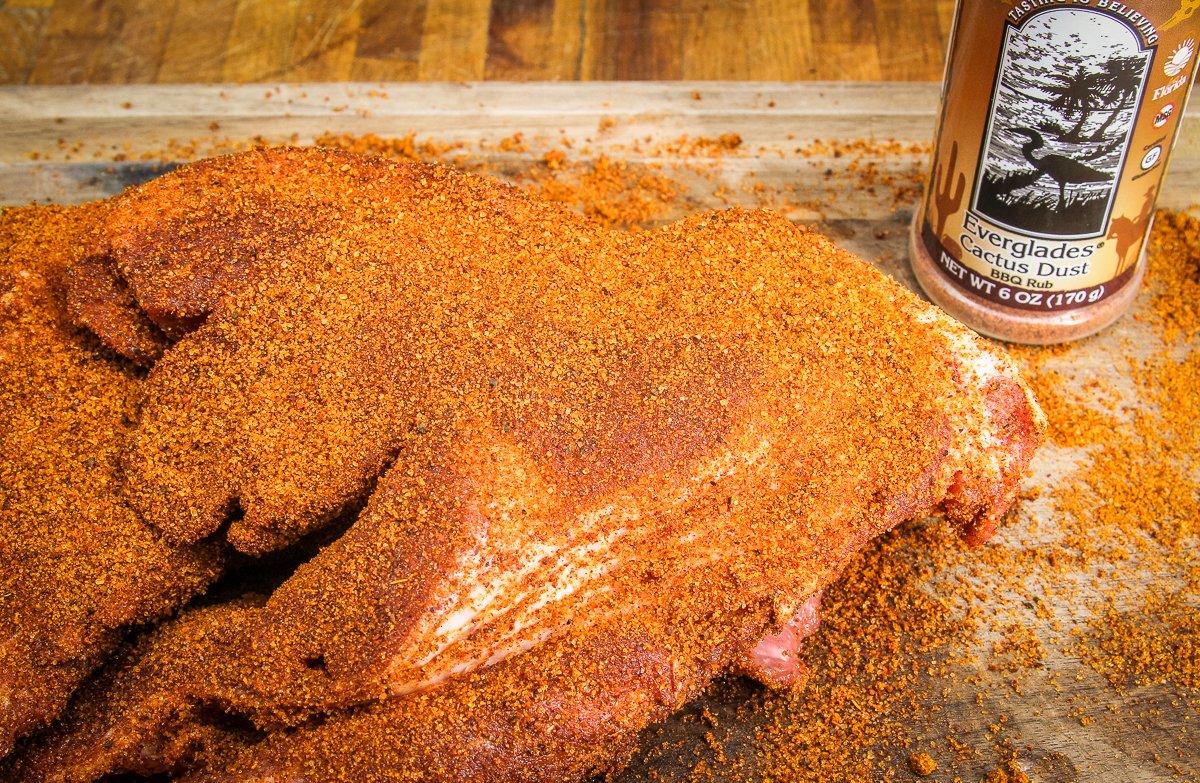 Coat a pork shoulder roast with BBQ rub and slow smoke it on your Traeger Grill.